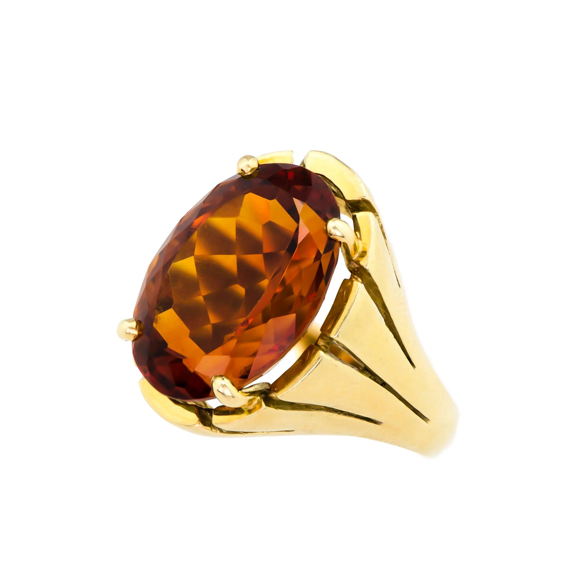 Vintage 18kt yellow gold and citrine ring set with one oval brilliant-cut deep rich colored citrine measures approximately 18.65mm by 13.1mm by 10mm into a heavy 18kt yellow gold mount. Approximately 12.95cts are estimated by formula.

Ring Size: