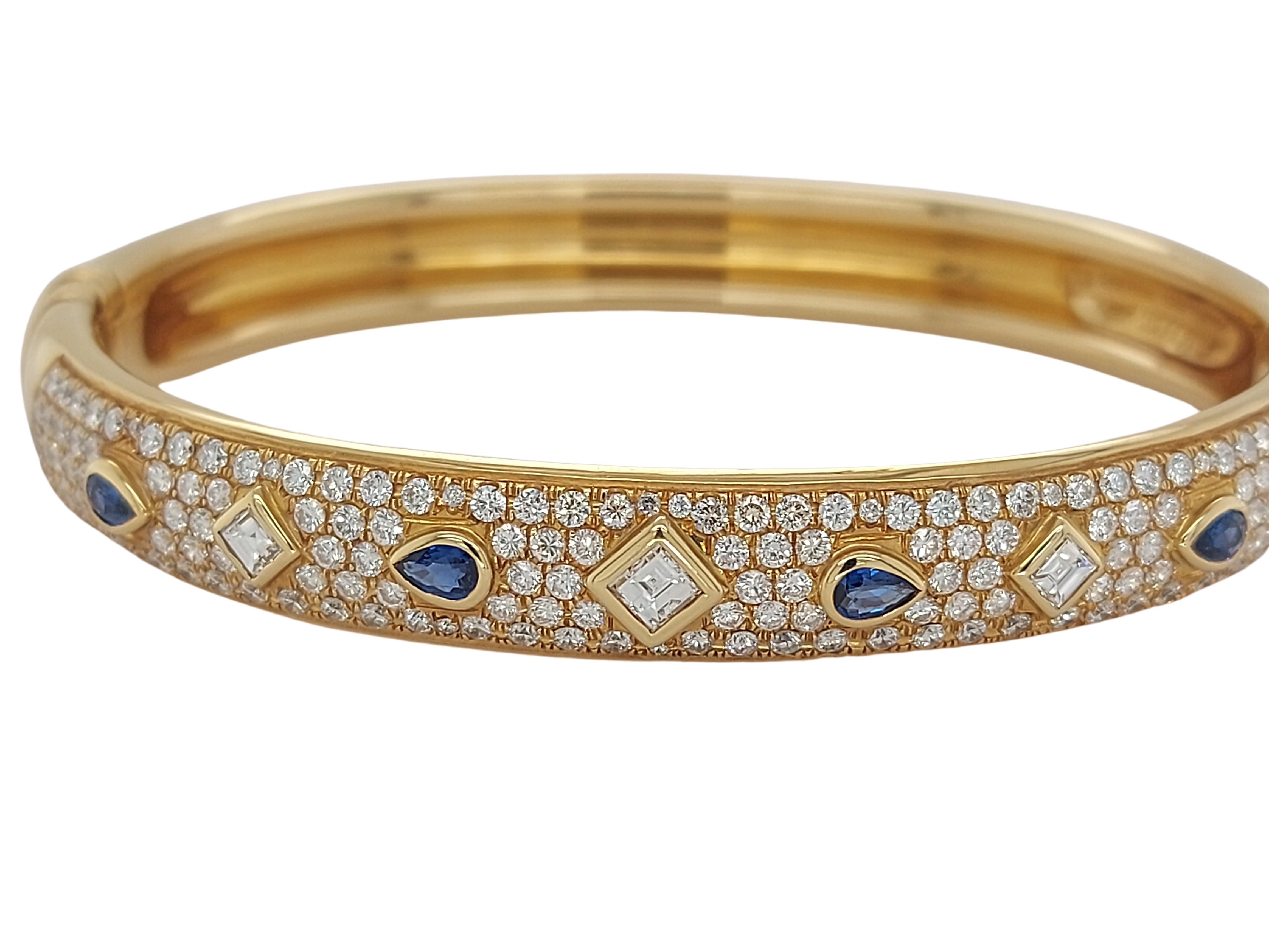 Vintage 18kt Yellow Gold Cartier Bangle Bracelet With Sapphire & Diamonds

Sapphire:  4 sapphires 

Diamonds: 200 brilliant cut diamonds / 3 square cut diamonds  

Material: 18kt Yellow gold

Total weight: 34.5 gram / 1.220 oz / 22.2