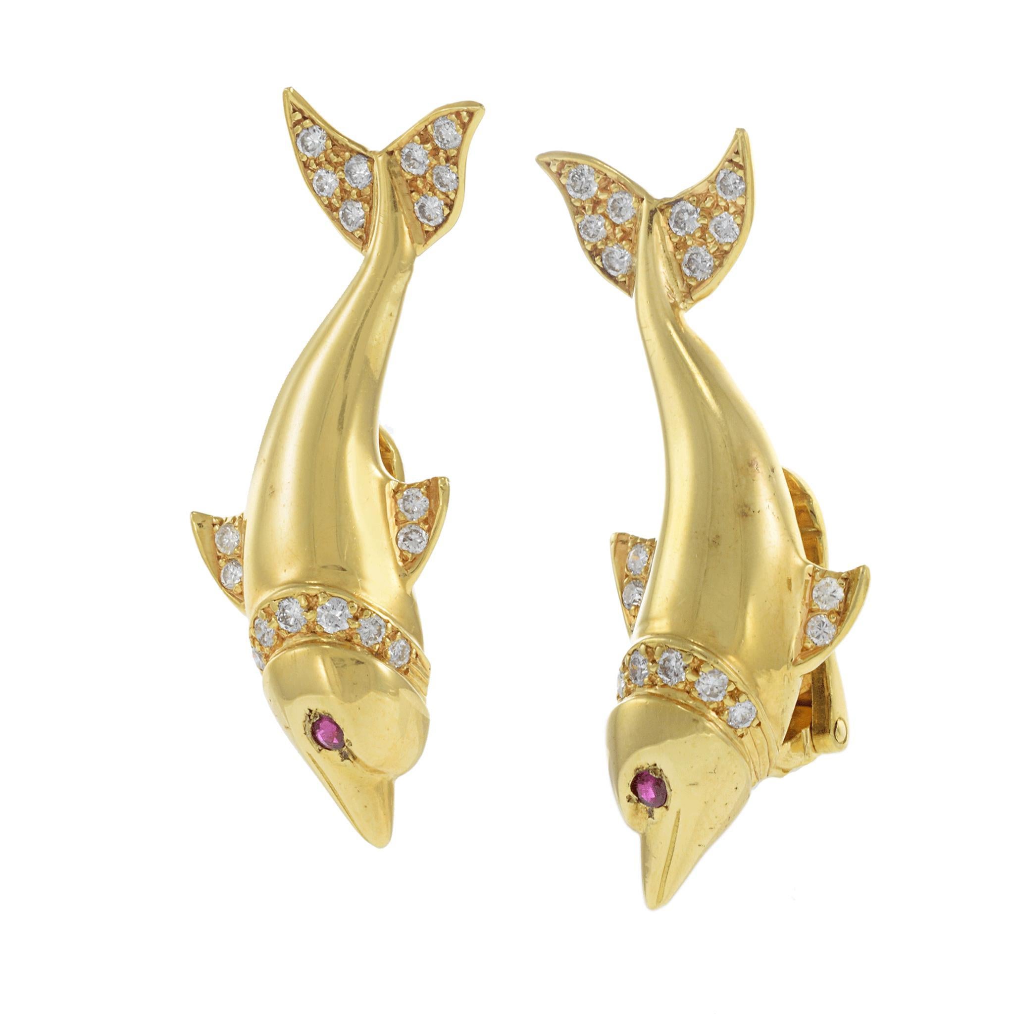 These whimsical yet refined vintage dolphin earrings are crafted in solid 18KT yellow gold and set with 0.95 carats of round brilliant diamonds and 0.08 carats of vivid rubies for the eyes. With G-VS1 diamond quality and fine ruby accents, each