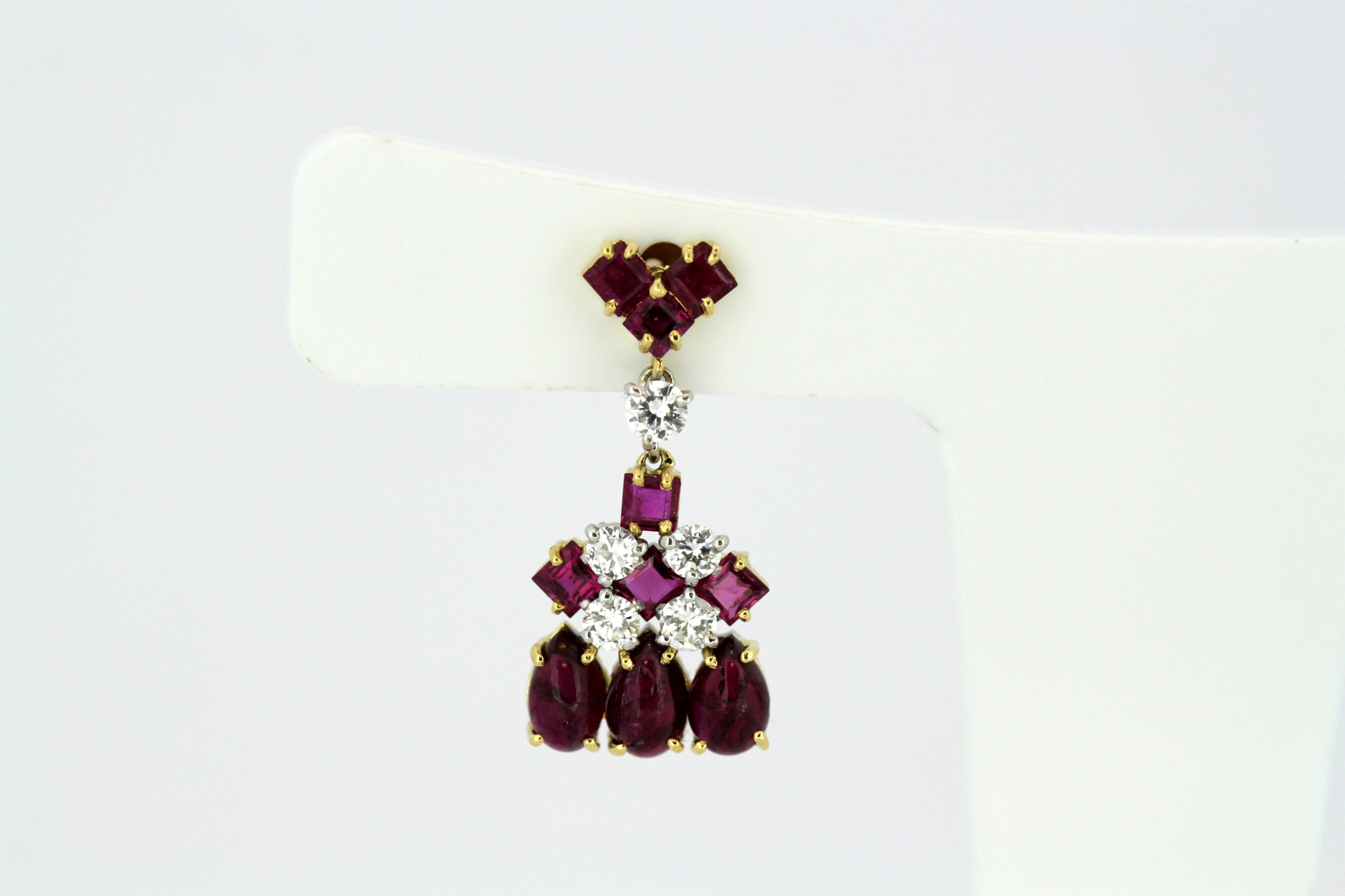 Vintage 18kt yellow gold ladies stud earrings with rubies and diamonds.
Studs are stamped 750.

Dimensions -
Size : 2.3 x 1.1 x 1 cm
Weight : 4 grams total

Rubies - 
Cut : Round & Pear
Total number of rubies : 20
Approx total weight : 1.16