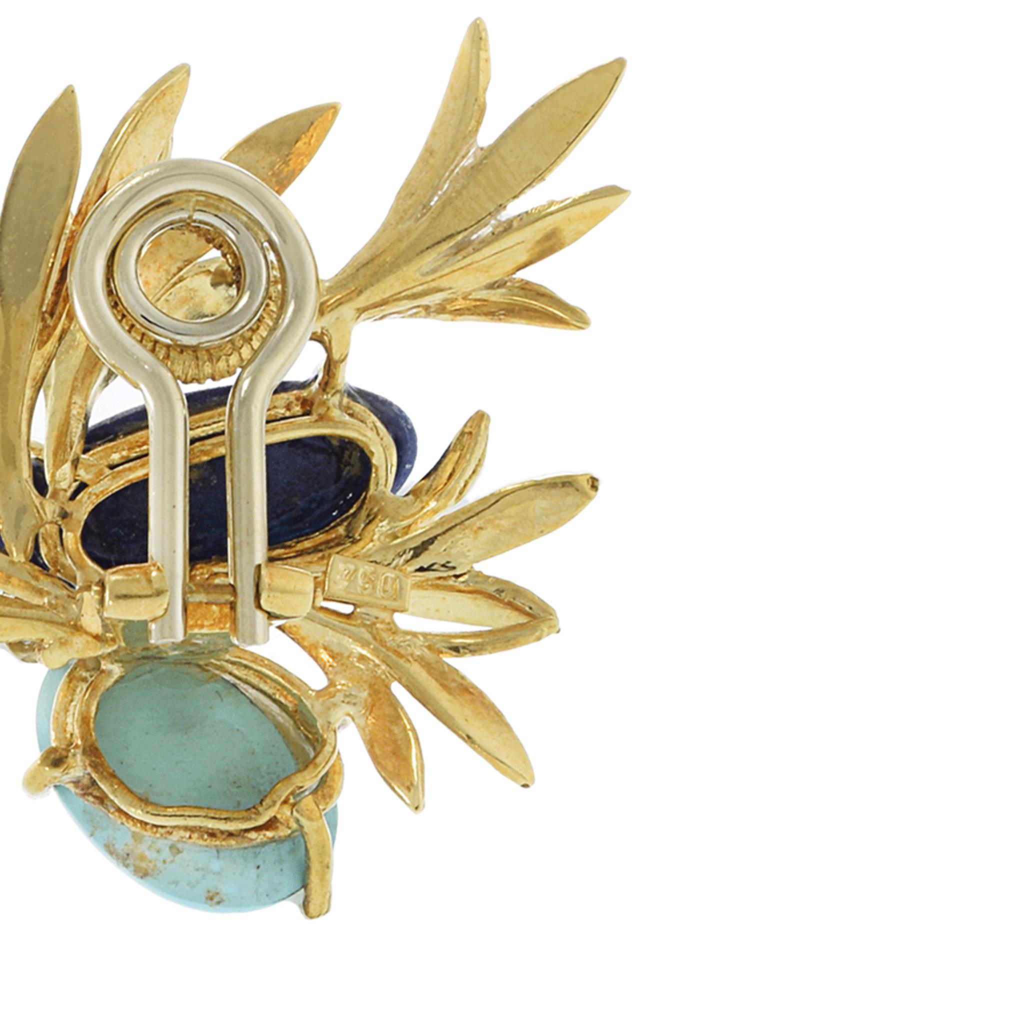 A sculptural pair of vintage earrings with vibrant movement and color. These 18KT yellow gold floral-inspired earrings showcase a dynamic pairing of lapis lazuli and turquoise cabochons nestled among hand-textured gold fronds. Each earring is