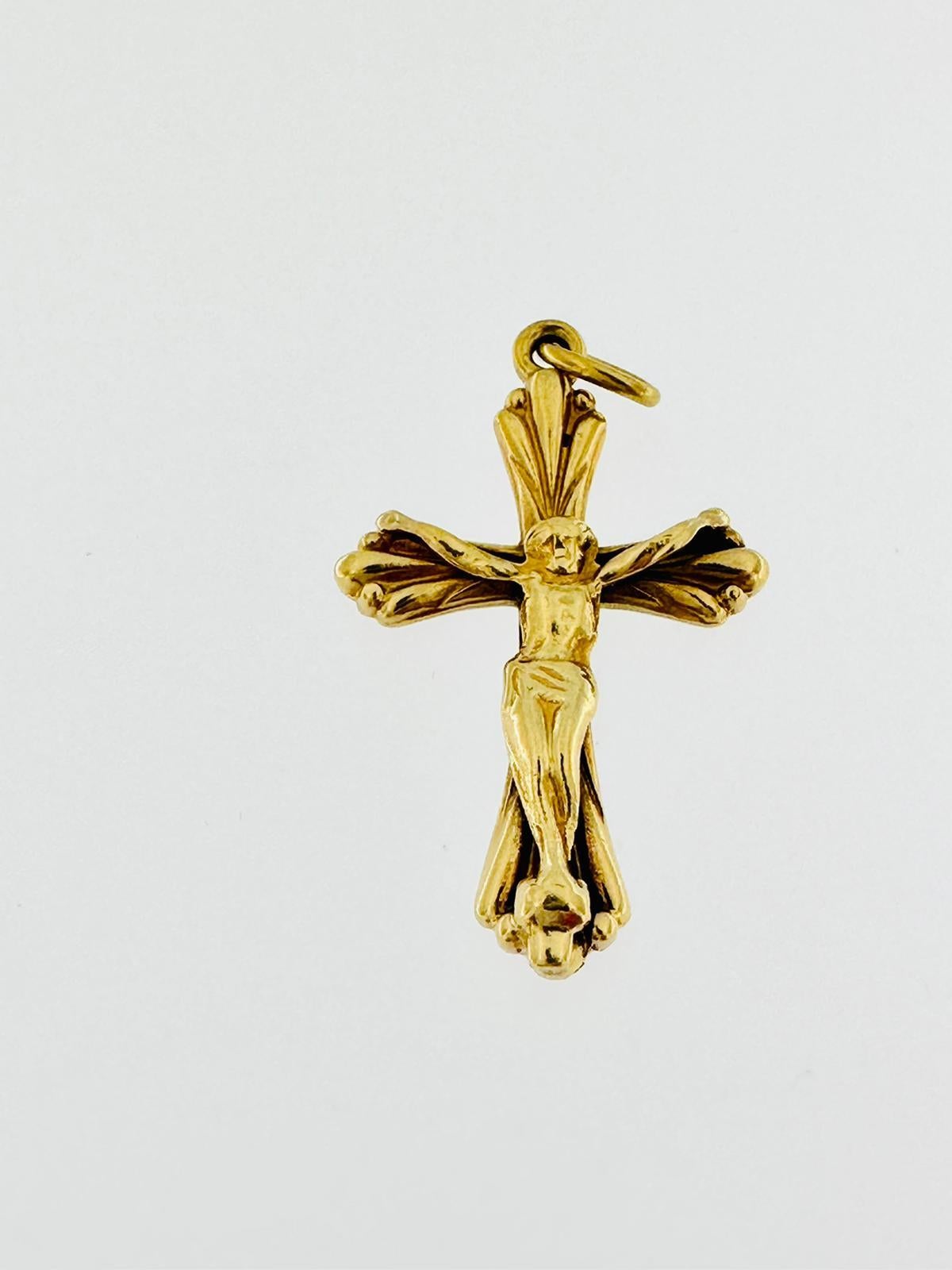The Vintage 18kt Yellow Gold Spanish Crucifix is a religious artifact that features a crucifix design and is made of 18-karat yellow gold. Crucifixes are symbolic representations of the Christian cross with Jesus Christ depicted on it, emphasizing