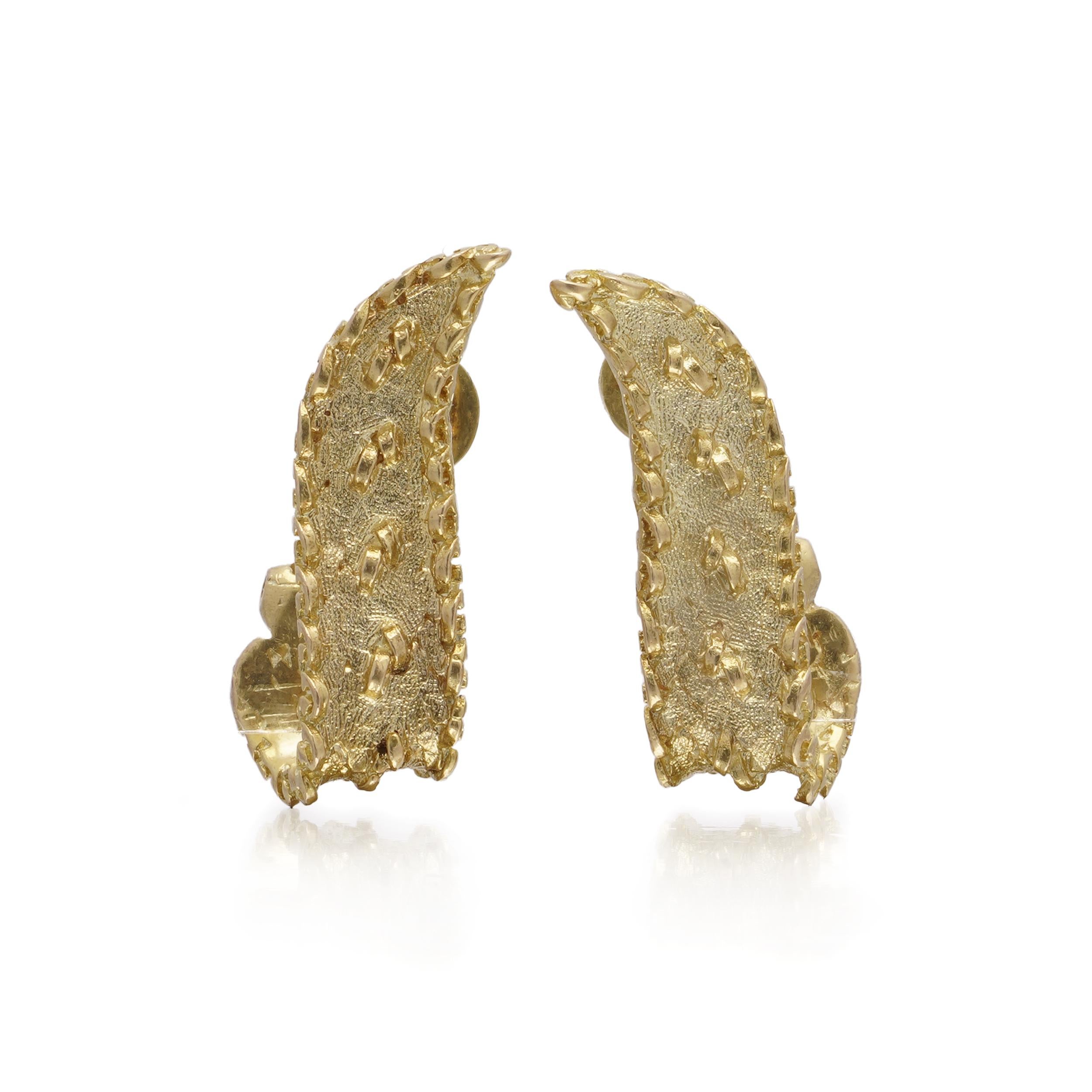 A sculptural pair of vintage clip-on earrings crafted in rich 18kt yellow gold, designed with an abstract, undulating form and heavily textured finish. 

Each earring is stamped with full English hallmarks for 18 carat gold, including the maker’s