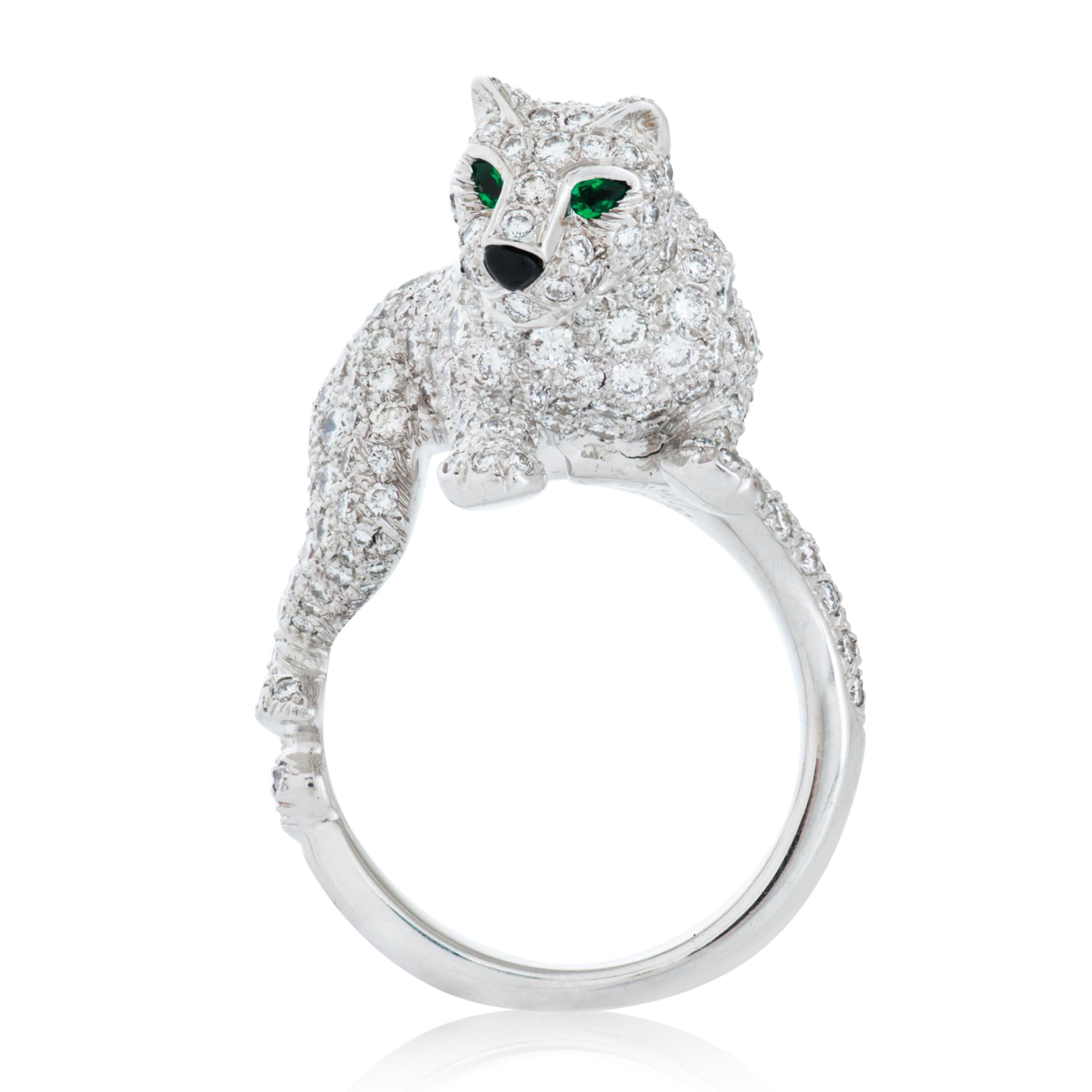 Vintage 18k white gold diamond Panthere De Cartier walking panther ring with emerald and onyx accents.

This Cartier ring features approximately 3.30 carat of round brilliant cut diamonds with F-G color and VS clarity, as well as two pear shape