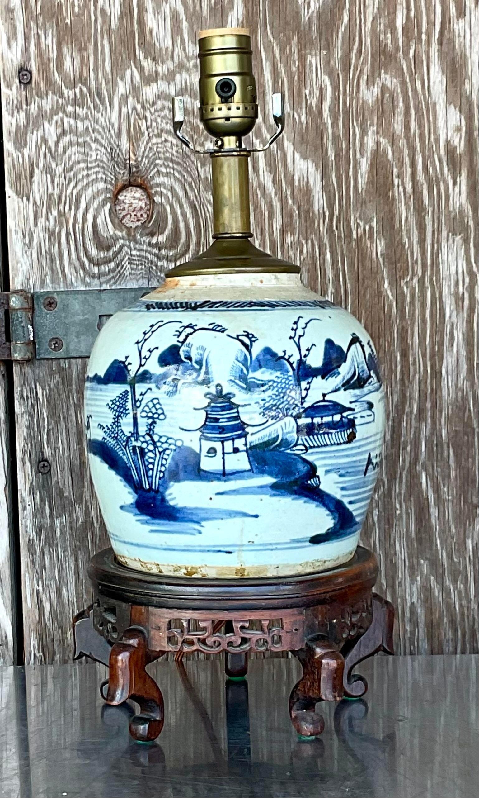 A gorgeous vintage 18th century Asian ginger jar lamp. In the color white with blue painted details. Acquired at a Palm Beach estate.