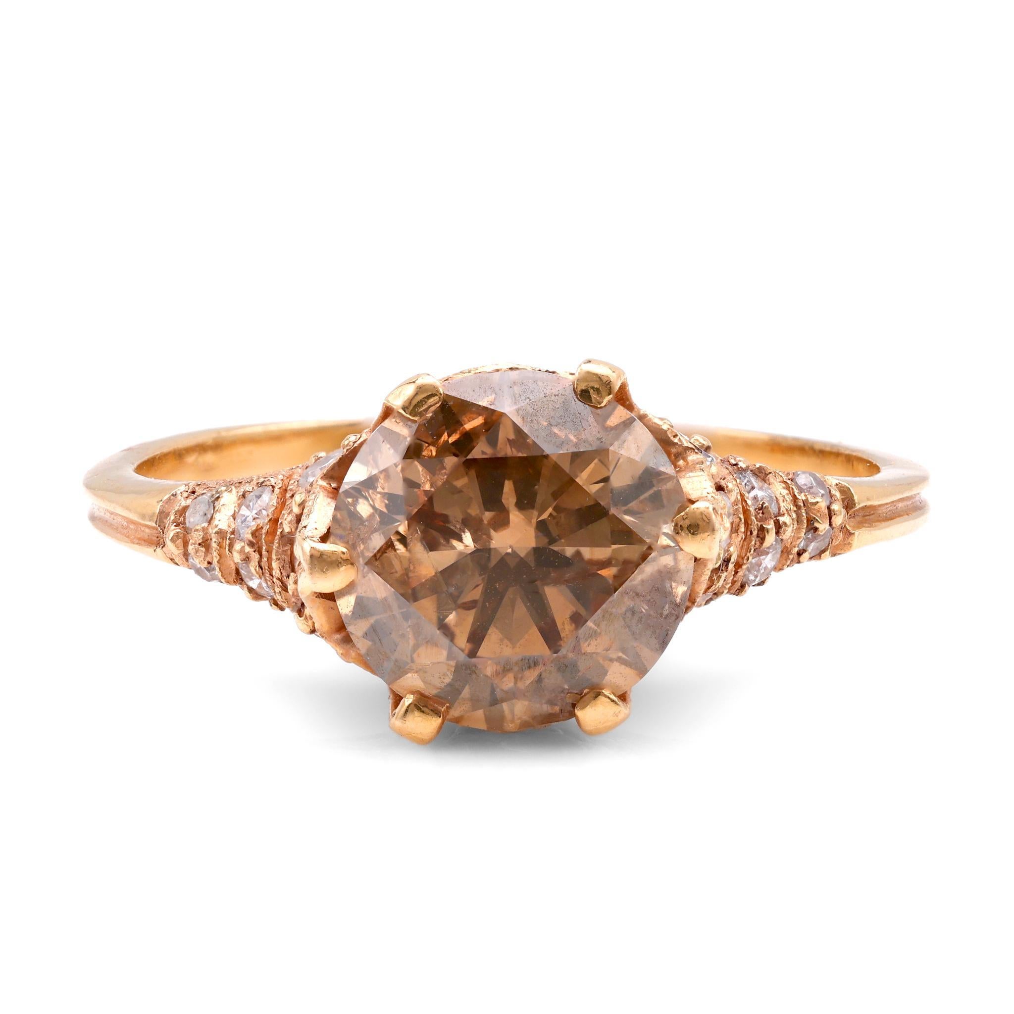 This exquisite vintage ring from the 1980s features a captivating round cut diamond at its center, weighing approximately 1.9 carats, with a unique fancy brown color and I1 clarity. Surrounding the center stone are 20 sparkling round and single cut