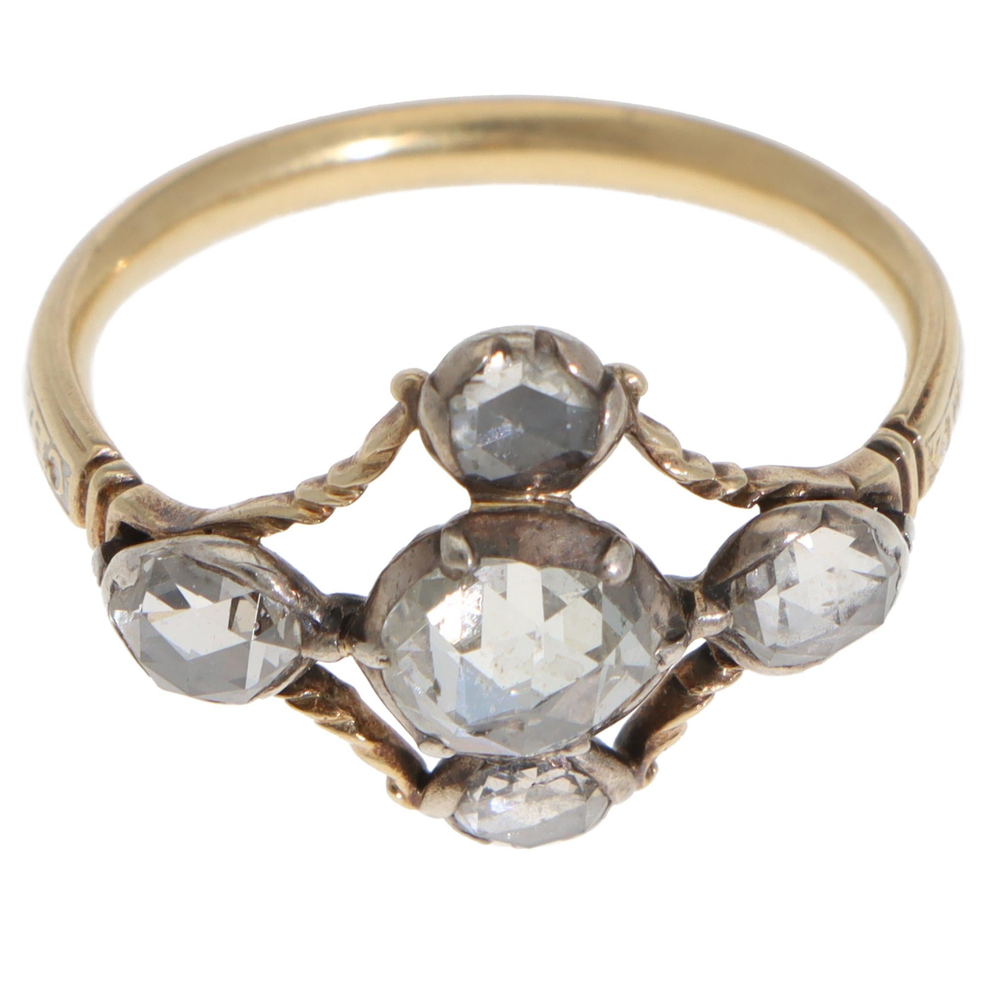A beautiful vintage Georgian rose-cut diamond cruciform ring set in silver and yellow gold, circa 1800's.

The ring is composed of 5 rose-cut diamonds in a cruciform motif. Each diamond is encased in a silver domed closed-back setting, which is