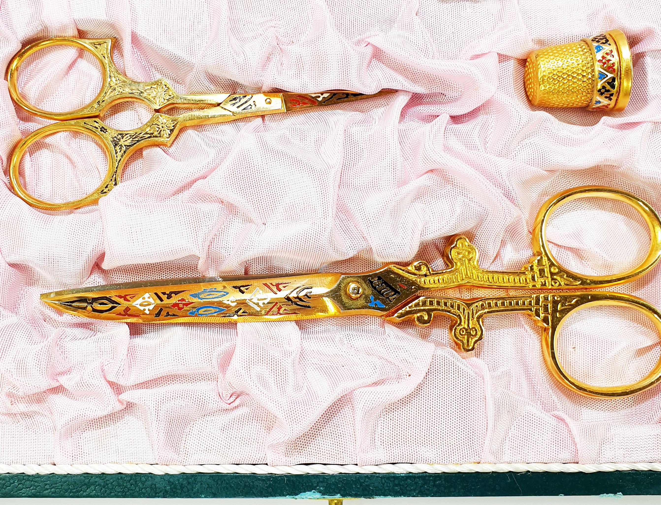 Unique  Toledo sewing kit from Spain. Steel scissors and thimble manufactured in the early to mid 1900's. All three pieces are gilded and beautifully engraved and decorated in damascene pattern. The blades are tight and sharp and cut all the way to