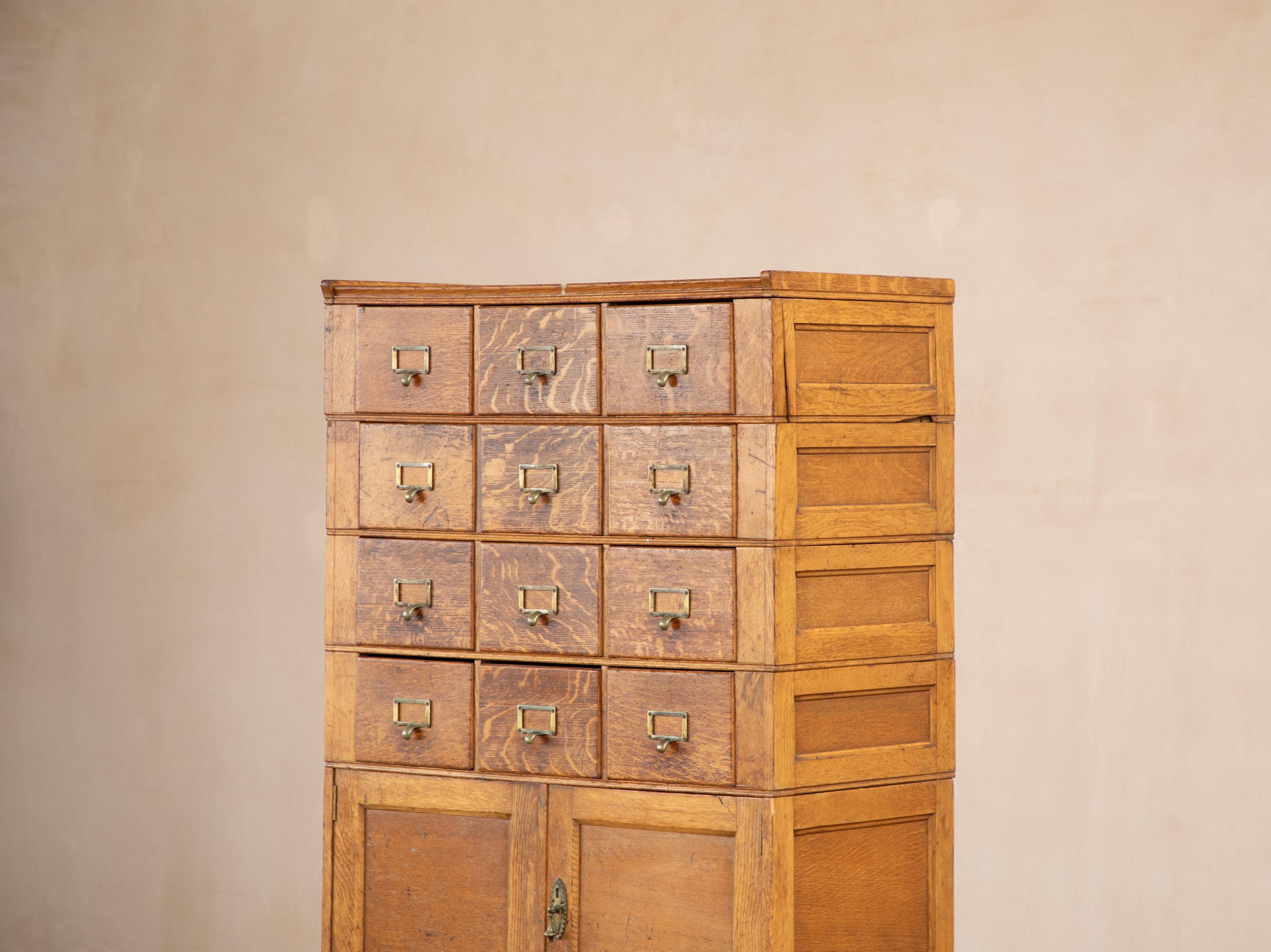 Vintage oak filling cabinet. Early 1900's industrial revolution. 
Taken from a Leicester knitwear factory, the cabinet has been there since the factory was built in the early 1900's.
This is a stacked system. Each set of drawers can be lifted off -