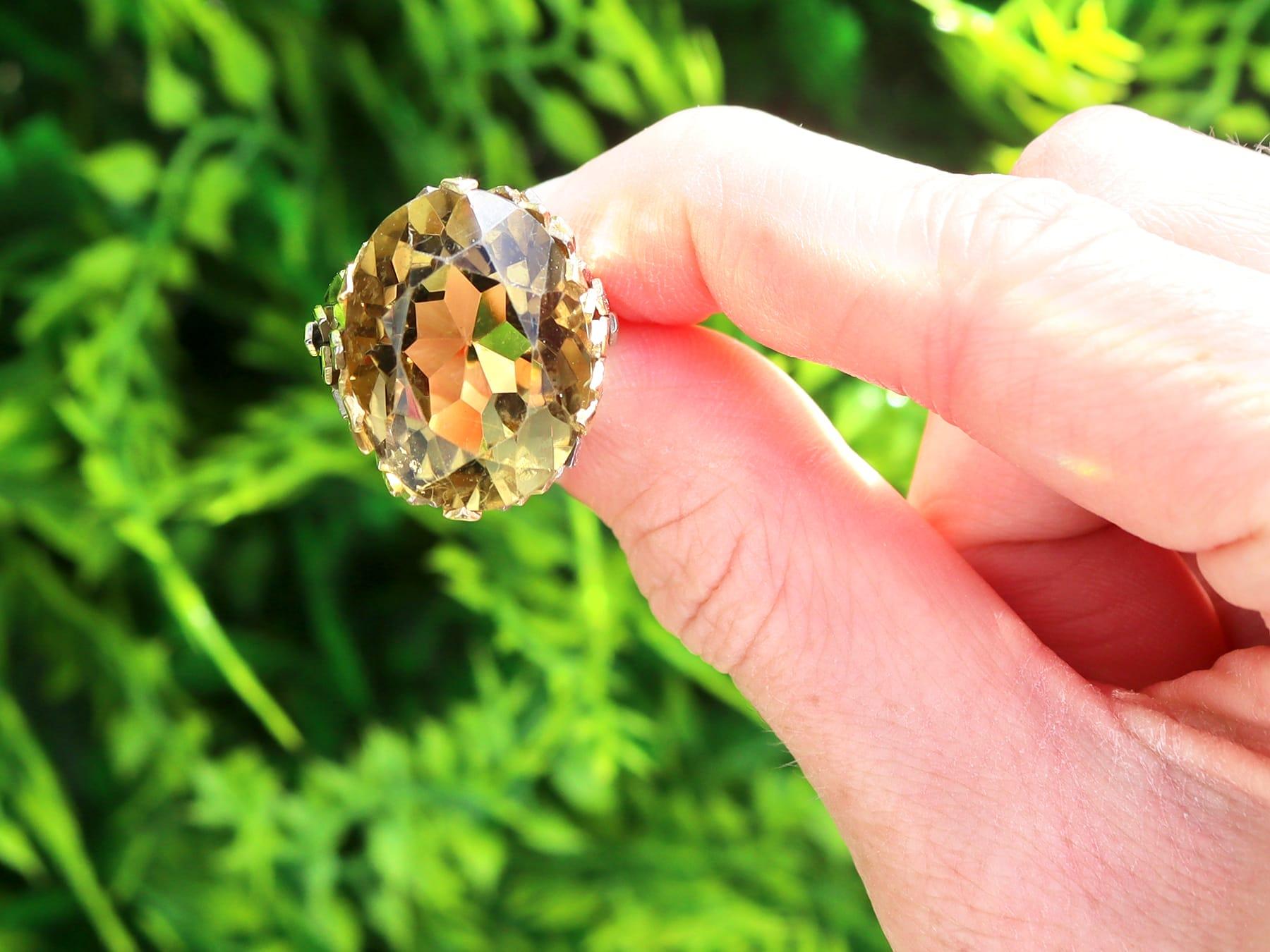 A stunning, fine and impressive vintage 19.05 carat smoky quartz and 18 karat yellow gold cocktail ring; part of our diverse vintage jewelry and estate jewelry collections.

This stunning, fine and impressive vintage quartz ring has been crafted in