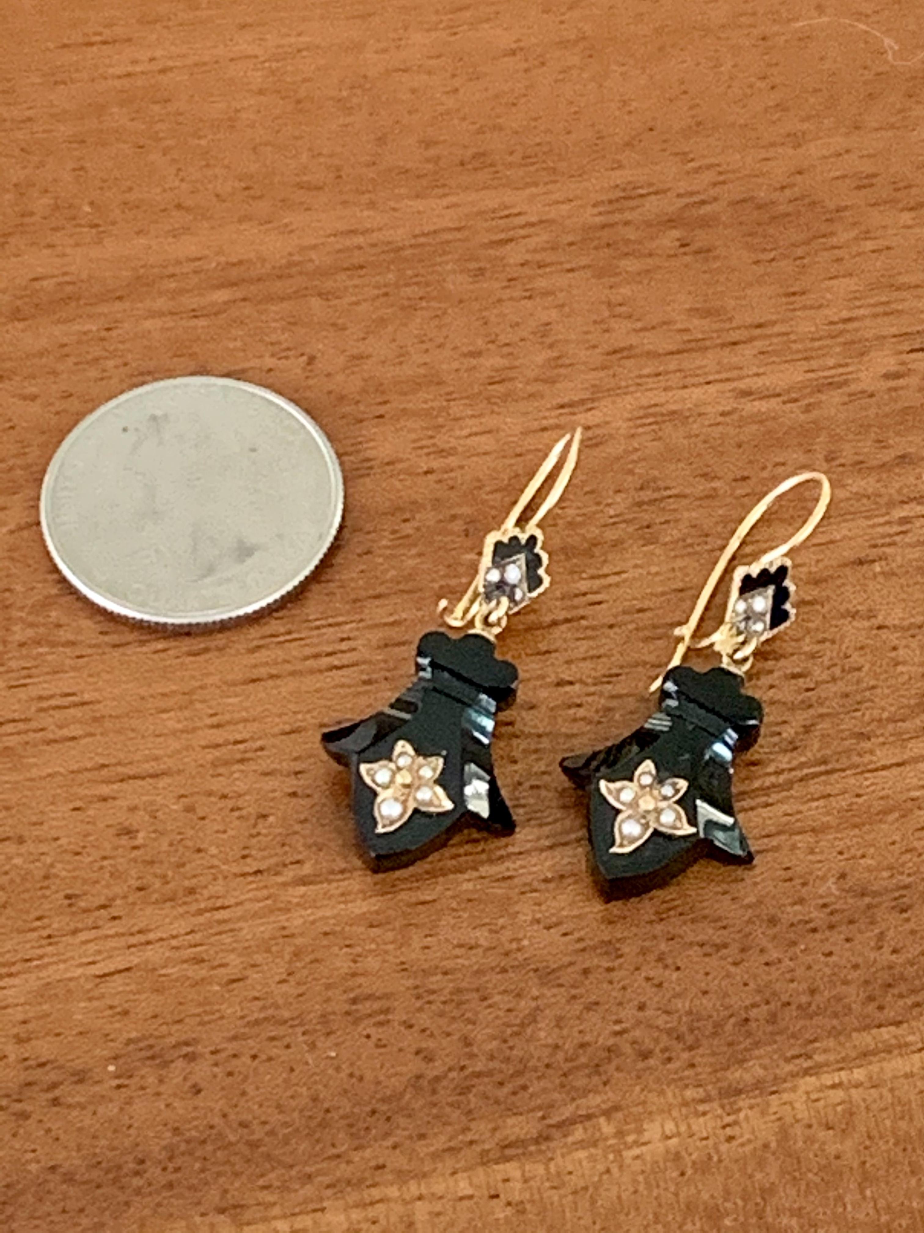 These fabulous, vintage 1910's to 1920's earrings feature a Trefoil-shaped piece of black Onyx which provides a backdrop to a seed Pearl flower design.  There is also a piece of black Onyx accented by seed Pearls which is on the piece of the earring