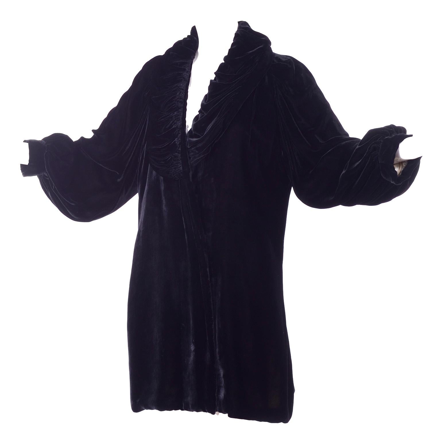 This is a gorgeous Edwardian vintage black velvet evening coat with a gathered puffy collar and puff sleeves. The coat is beautifully lined in pale pink silk satin. This coat has a tie on the inside that closes one side but no closure for the other.
