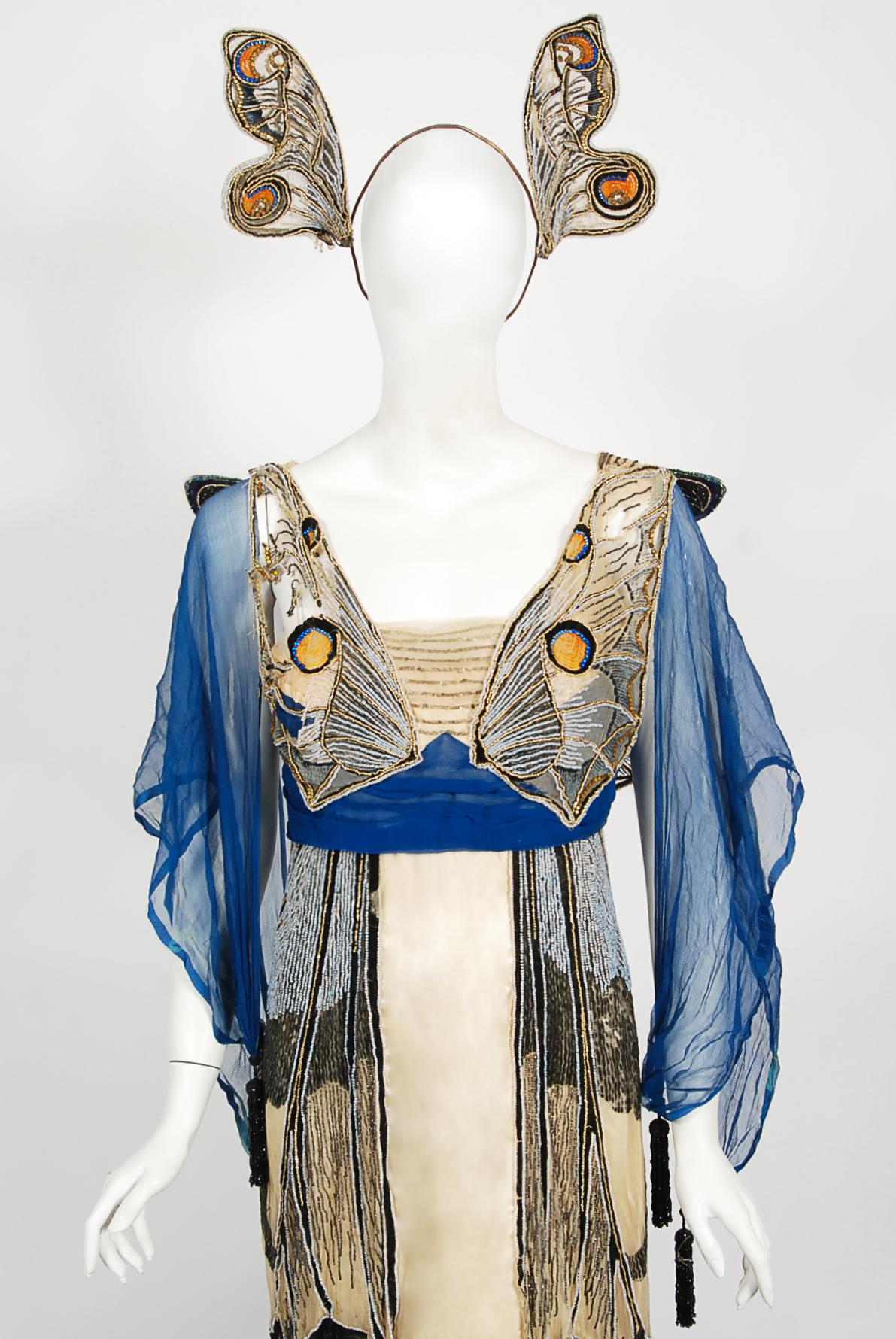 An absolutely magically and incredibly rare museum worthy House of Worth by Jean-Philippe Worth haute couture butterfly motif Art Nouveau trained gown and matching metal headpiece dating back to 1912. This elaborate gown was custom commissioned by