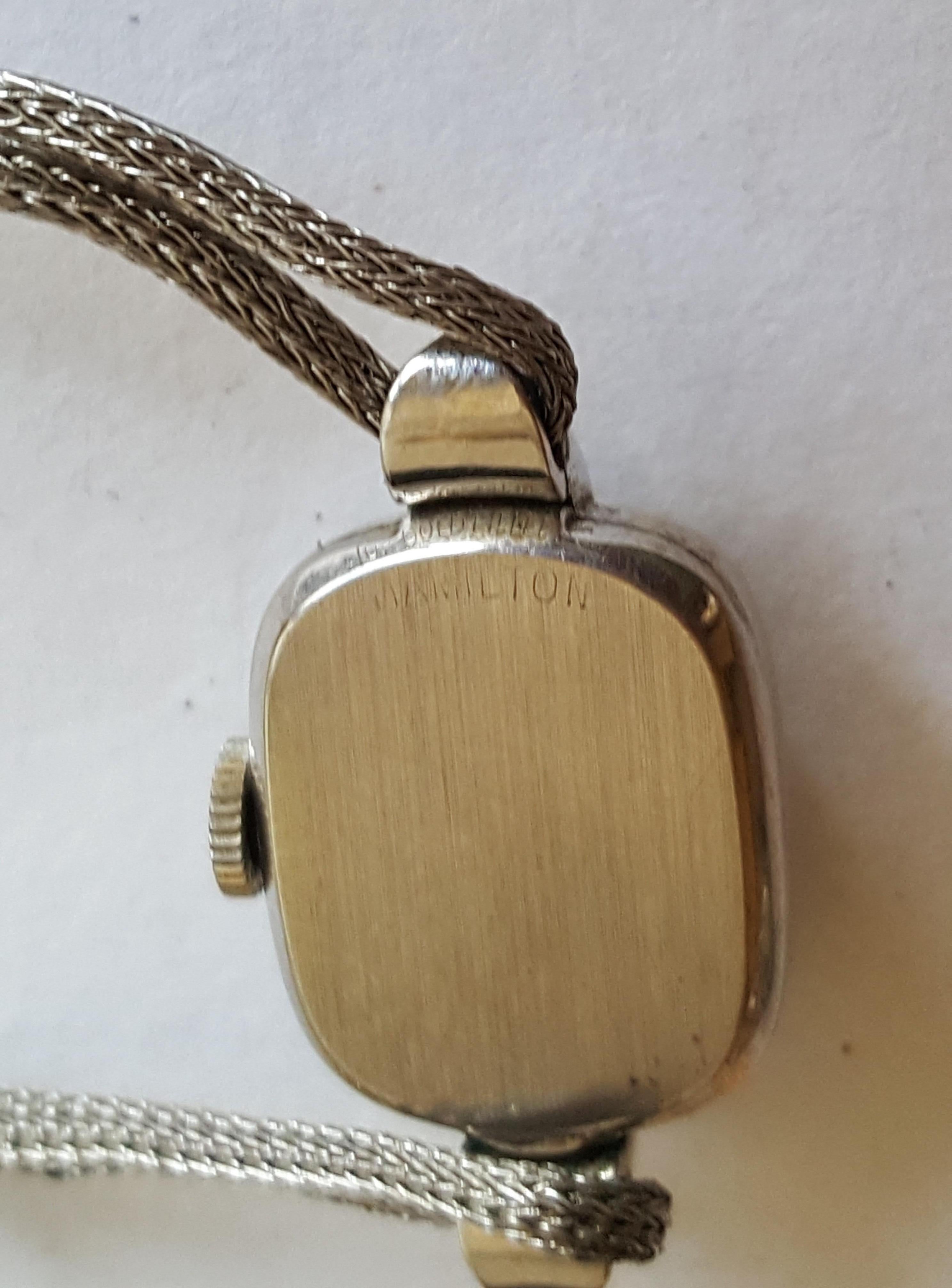 Vintage 1920-30's Gruen Precision Watch, 10kt Gold Filled, 15mm x 17mm Case, Gold Numerals, Off White Face, Hamilton Case, Kreisler 10Kt White gold and Stainless Steel Strap. Fold clasp, Not working. Mesh strap has some fraying. Strap is petite, 5