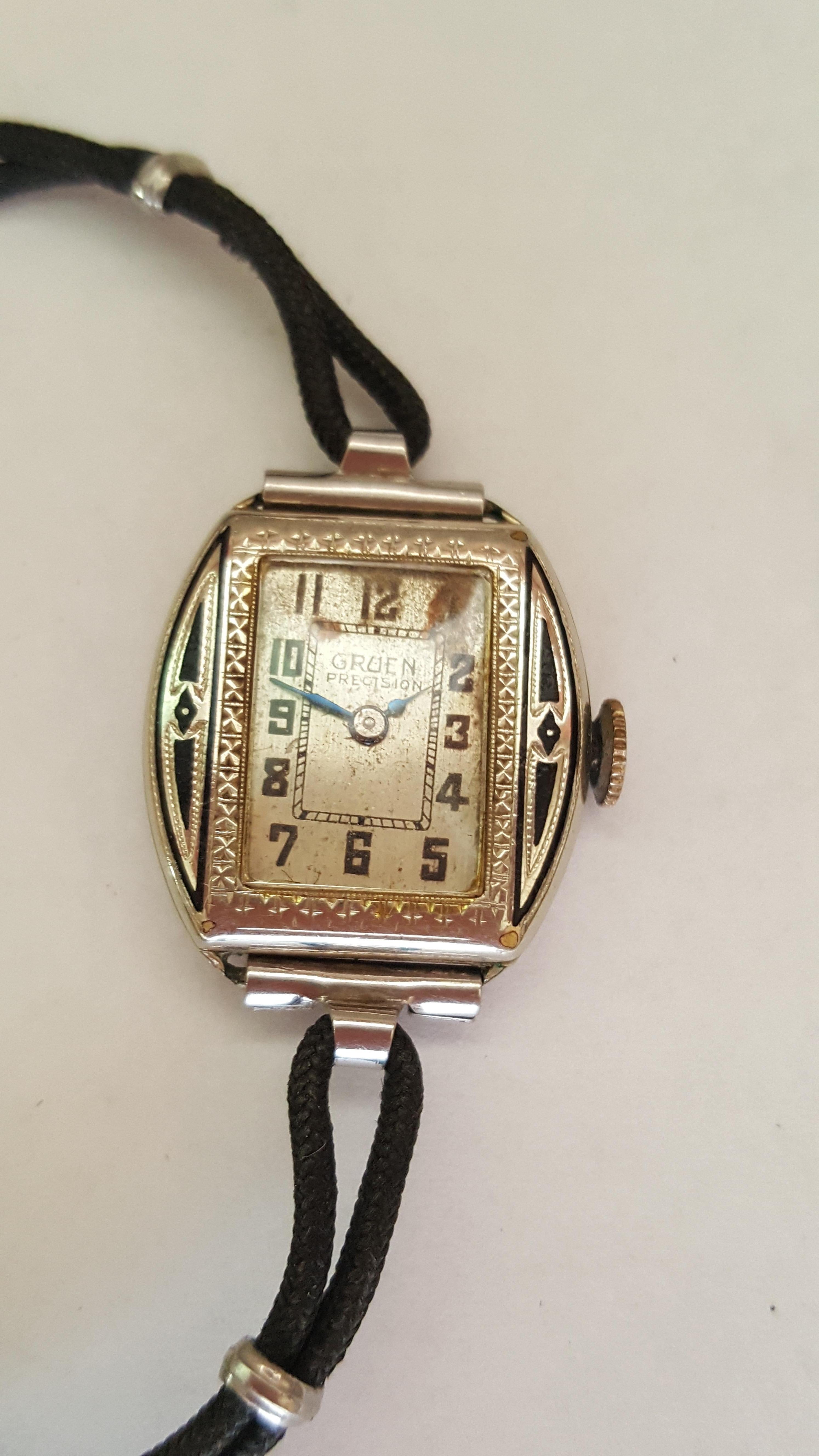 Vintage 1920's Gruen Precision ladies watch in fair condition.  This watch has detailed engraving and satin finish detail accented with black antiquing. This watch is perfect for a collector who'd likes to work on watches. The bracelet is a black