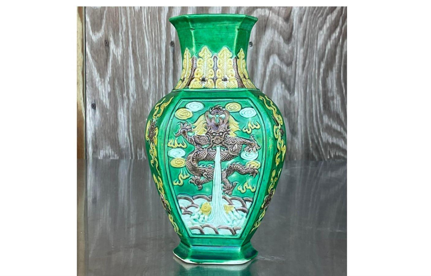 A fabulous vintage 1920s Asian vase. A chic green and yellow form with a dragon motif. Stamped on the bottom. Acquired from a Palm Beach estate. 