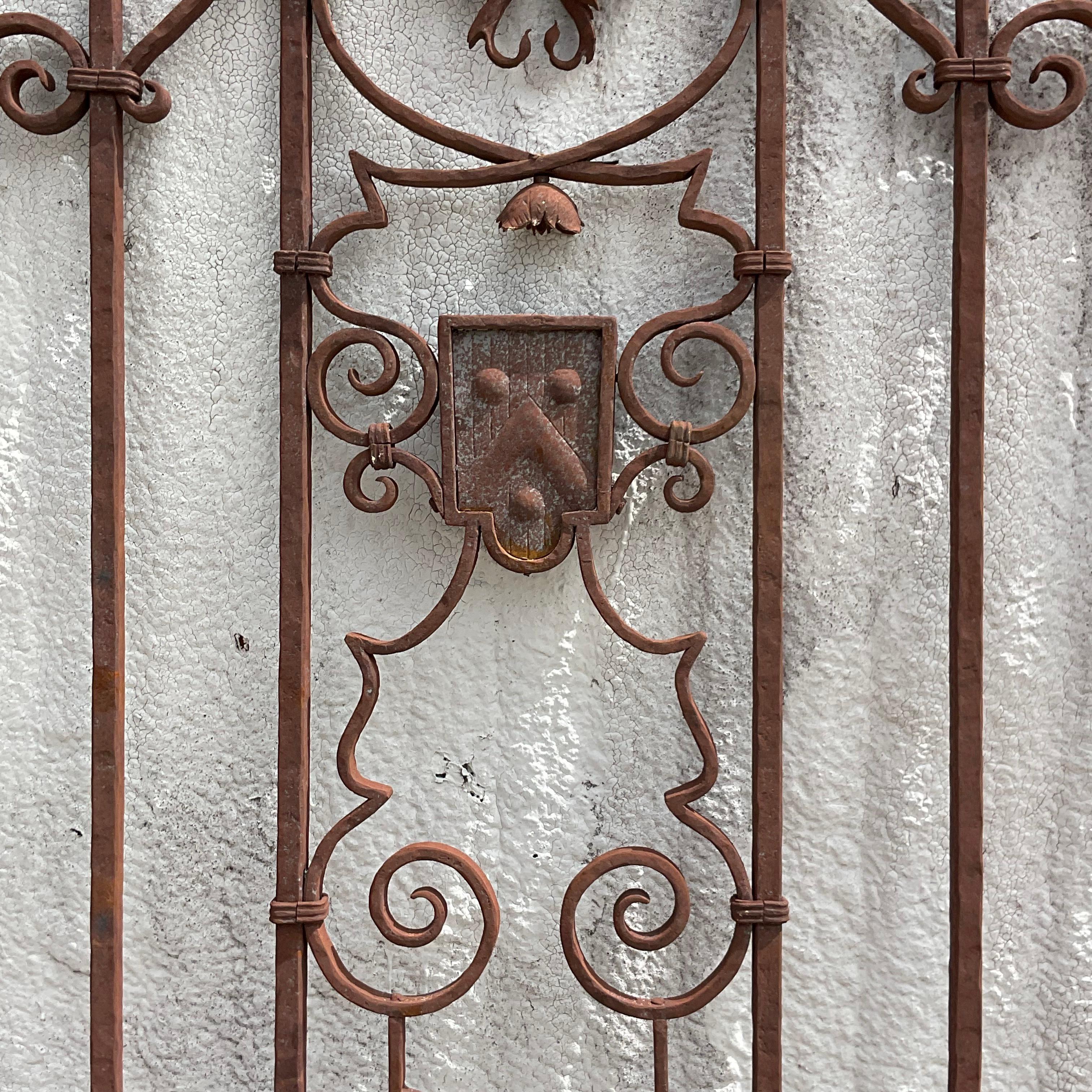 A spectacular vintage monumental Boho wrought iron gate. Done in the manner of Addison Mizner. Acquired from a 1920s Palm Beach estate.