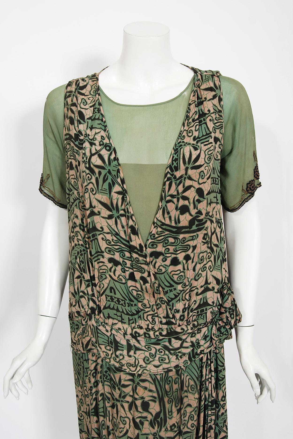 There are lots of lovely 1920's garments still around, but every once in a while I come across one that sets my heart a flutter! This is an incredibly unique 1920's sage-green silk dress with a captivating Chinese architecture scenic print. I love