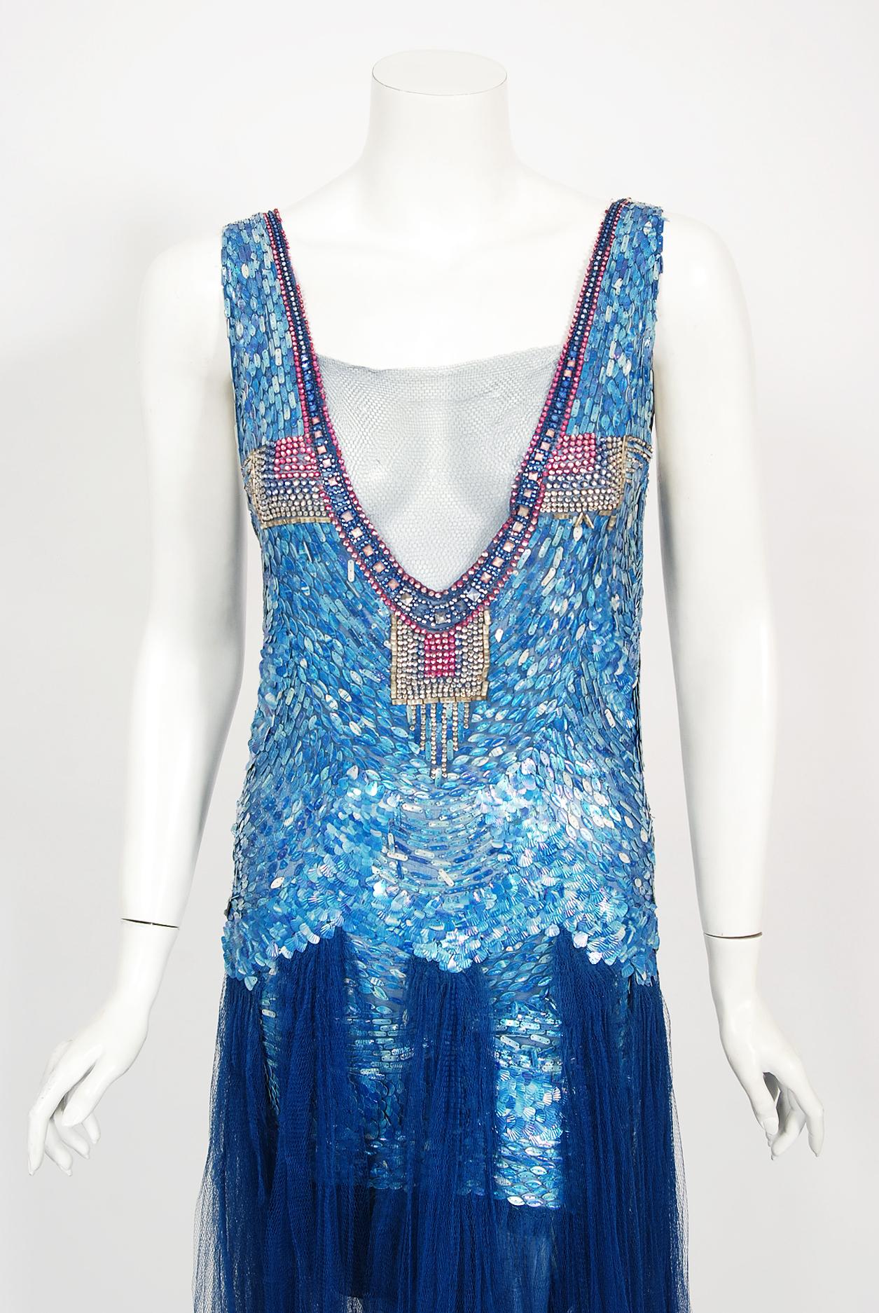 Breathtaking French museum quality sparkling net-tulle mermaid flapper gown dating back to the mid 1920's. The royal blue color palette touches a deep chord in our collective aesthetic consciousness. As fashion lovers, we never tire from antique