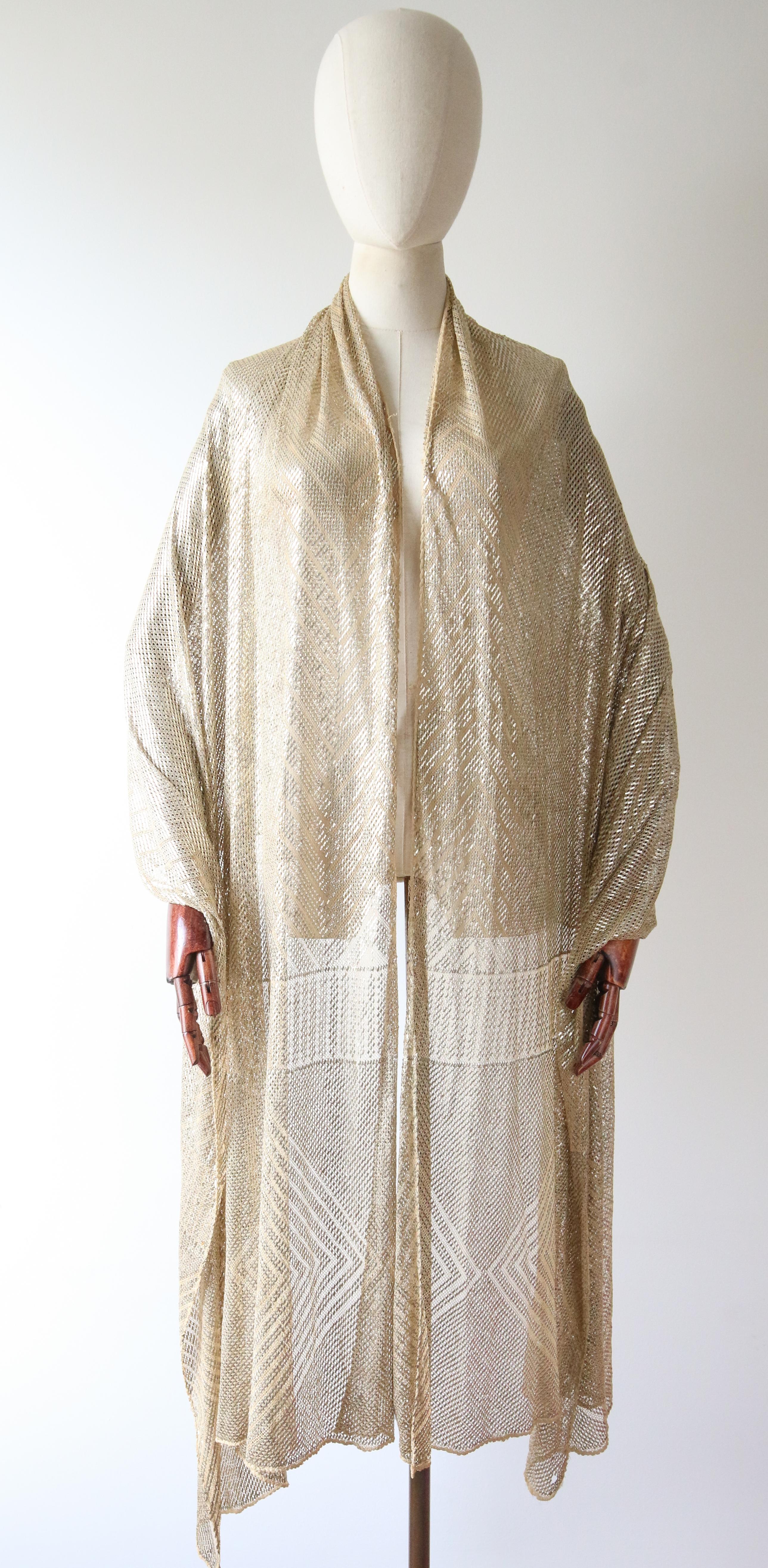 This breathtaking 1920's cream cotton mesh asssuit shawl, stamped with a grid and geometrical diamond design along each of the extremities, is a piece of true fashion history.

Her wonderful weight, allows for the shawl to drape effortlessly over