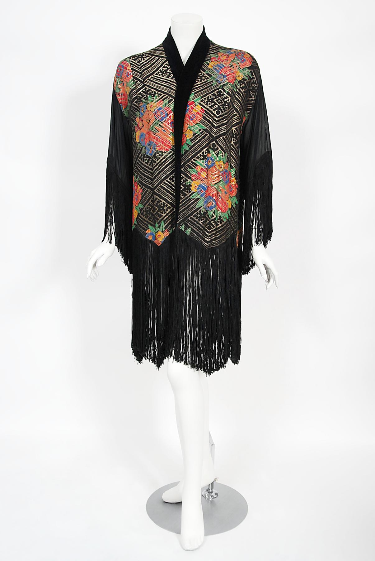 An exceptional French sparkling silk lamé and black sheer chiffon flapper jacket dating back to the mid 1920's. It is easy to find fringed shawls, but this is an actual art deco jacket made of the finest luxury textures. The fabrics combinate