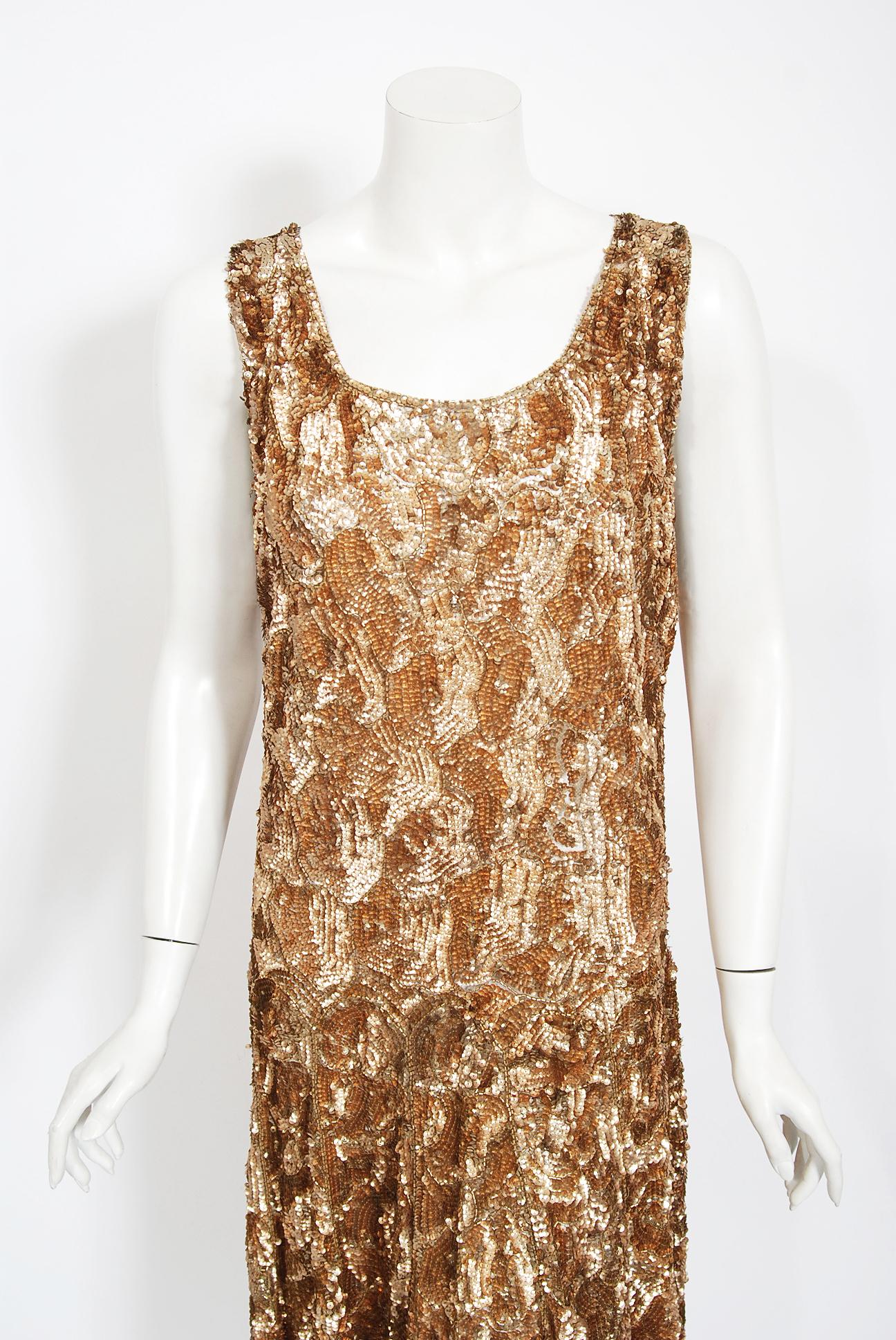 Breathtaking 1920's French sparkling cotton-net flapper dance dress. The metallic golden color palette mixed with the unique fish scales deco pattern touches a deep chord in our collective aesthetic consciousness. As fashion lovers, we never tire