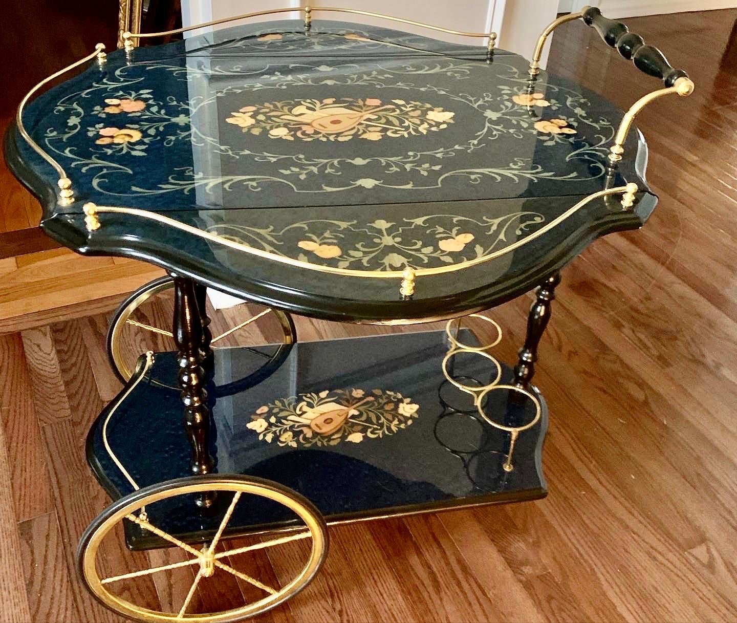 Beautiful Italian inlaid marquetry bar cart with brass accent and drop leaves. Two large carriage style front wheels and one small swivel caster rear one. All wheels operate smoothly. Lovely, vibrant detail throughout with hand painted guitar and