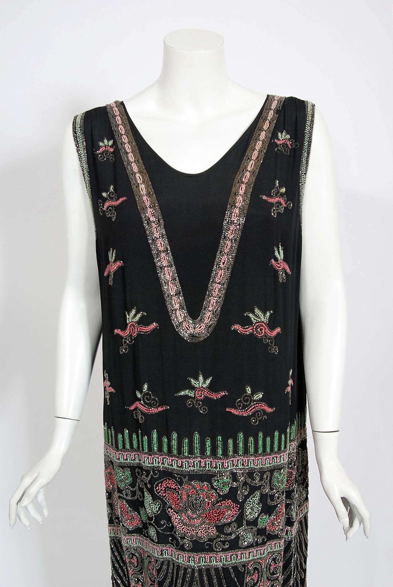 Absolutely gorgeous and extremely rare hand beaded Jean Patou haute couture attributed dress dating back to the mid-1920's. Undiminished by time, this black silk beauty looks as though she just walked off of a Paris fashion runway.  The high quality