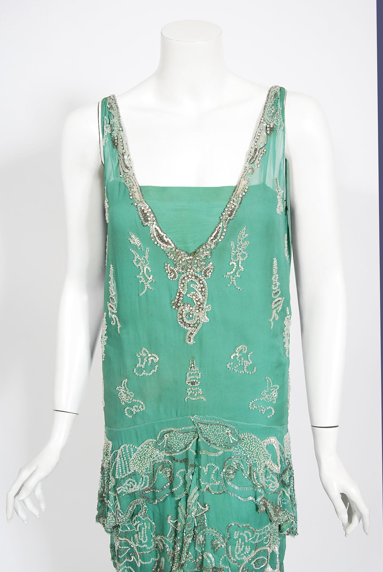 Absolutely gorgeous and extremely rare hand beaded Jean Patou haute couture attributed dress dating back to the mid-1920's. As shown, in my research I found an almost identical dress with the same novelty beaded Asian themed motif. From the start of