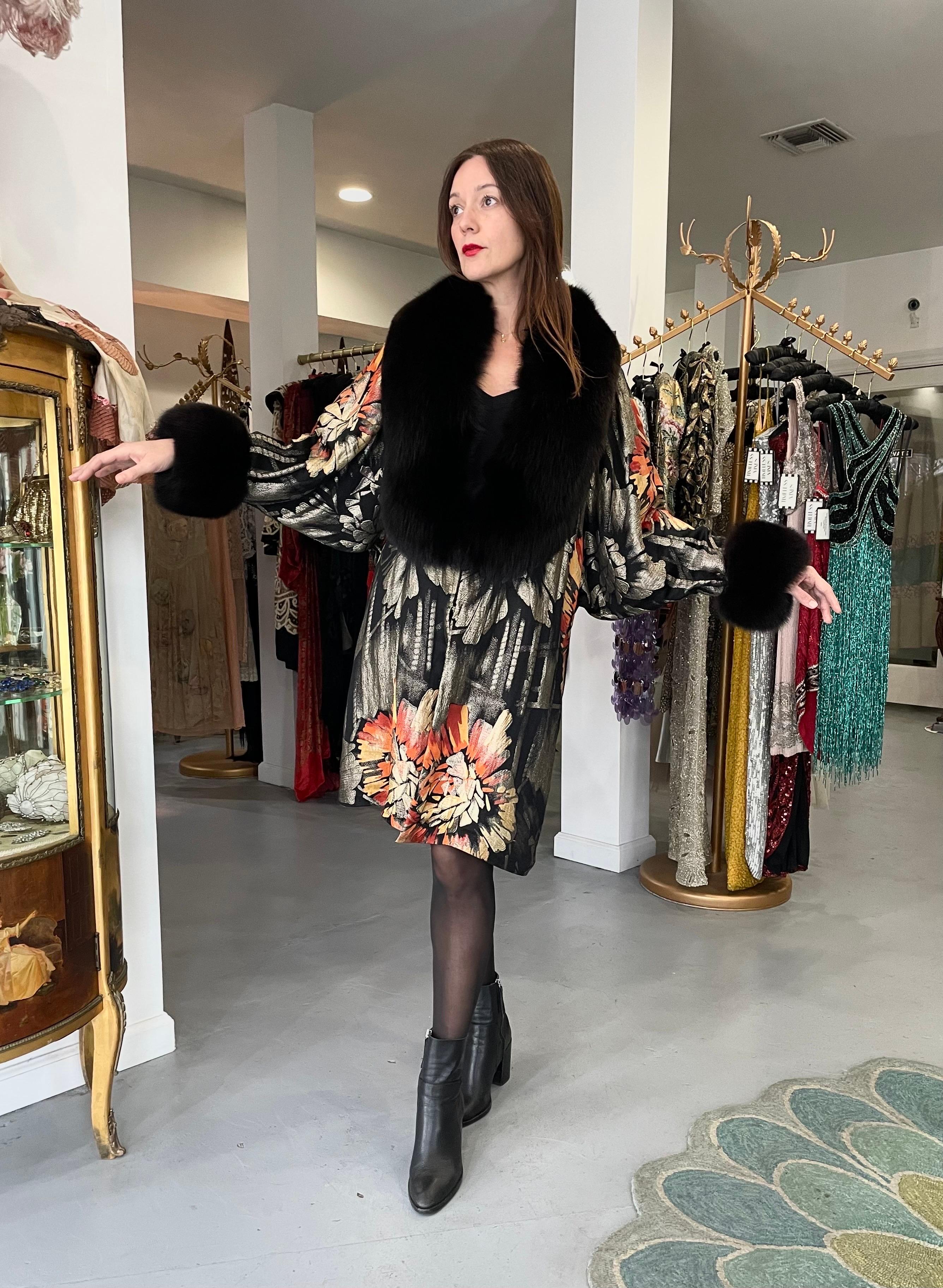 An absolutely gorgeous and ultra rare French metallic graphic floral print lamé & black fox-fur coat dating back to the mid 1920's. Evening garments from the flapper era remain a perennial favorite, perhaps because no other period combined opulence