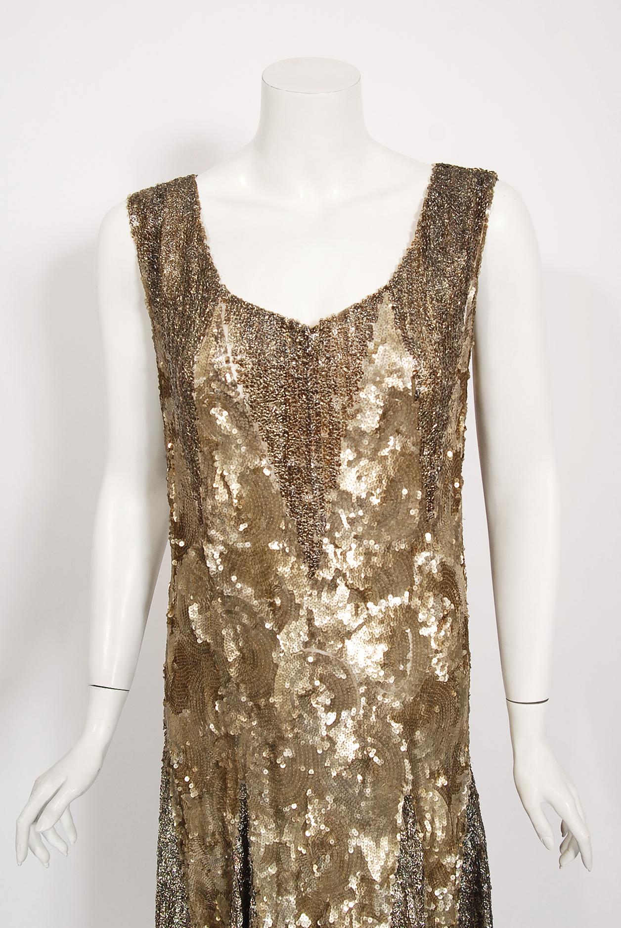 Breathtaking 1920's French sparkling cotton-net flapper dance dress. The metallic golden color palette mixed with the unique deco pattern touches a deep chord in our collective aesthetic consciousness. As fashion lovers, we never tire from antique