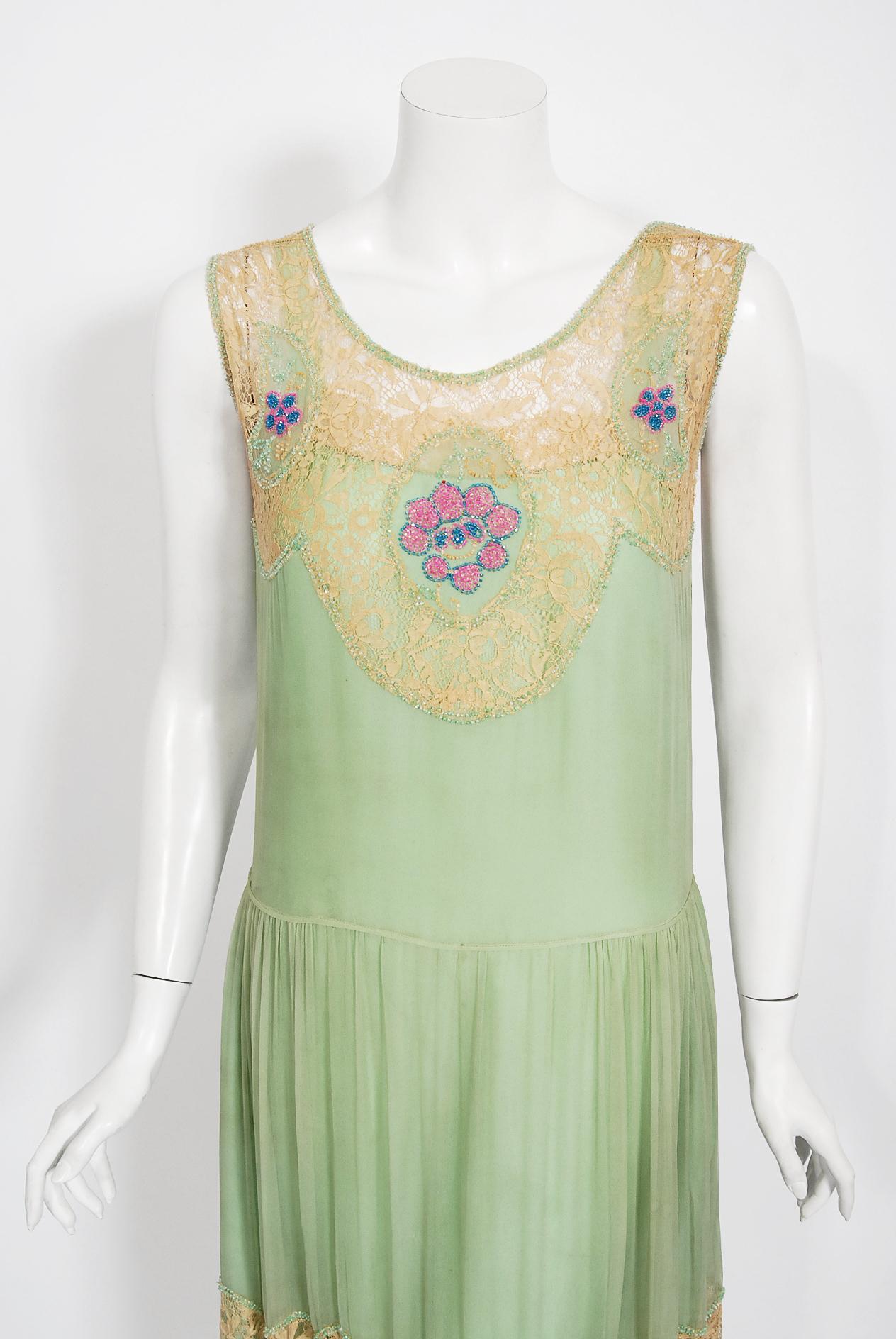 Undiminished by time, this 1920's mint-green dance dress still casts its magical spell. Like a Great Gatsby fairy! This exceptional French beauty is fashioned in three different fabrics- mint green chiffon, ecru lace and a built-in silk camisole. It