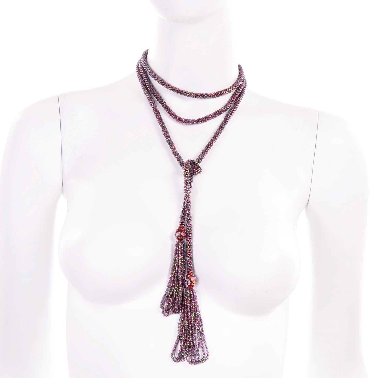This is a lovely iridescent purple and red beaded flapper tassel necklace with fringed ends and accent lampwork or wedding cake beads. The Sautoir rope style necklace measures 60