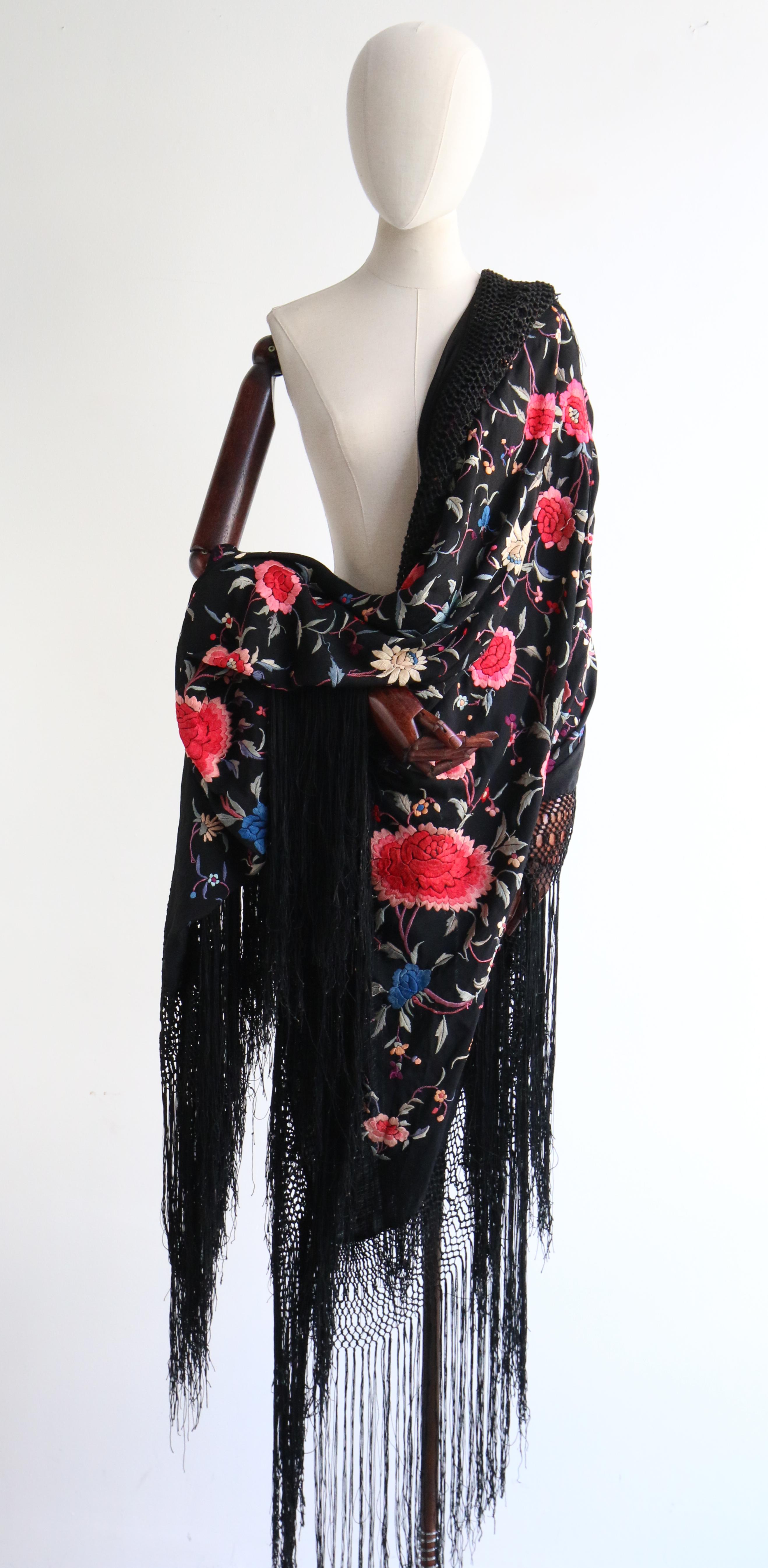 This magnificent 1920's large silk square shawl, in the darkest shade of midnight black, is the perfect accessory for your vintage collection.

Fully embellished in silk floral embroidery, in shades of pink, blue, green, cream and purple in a