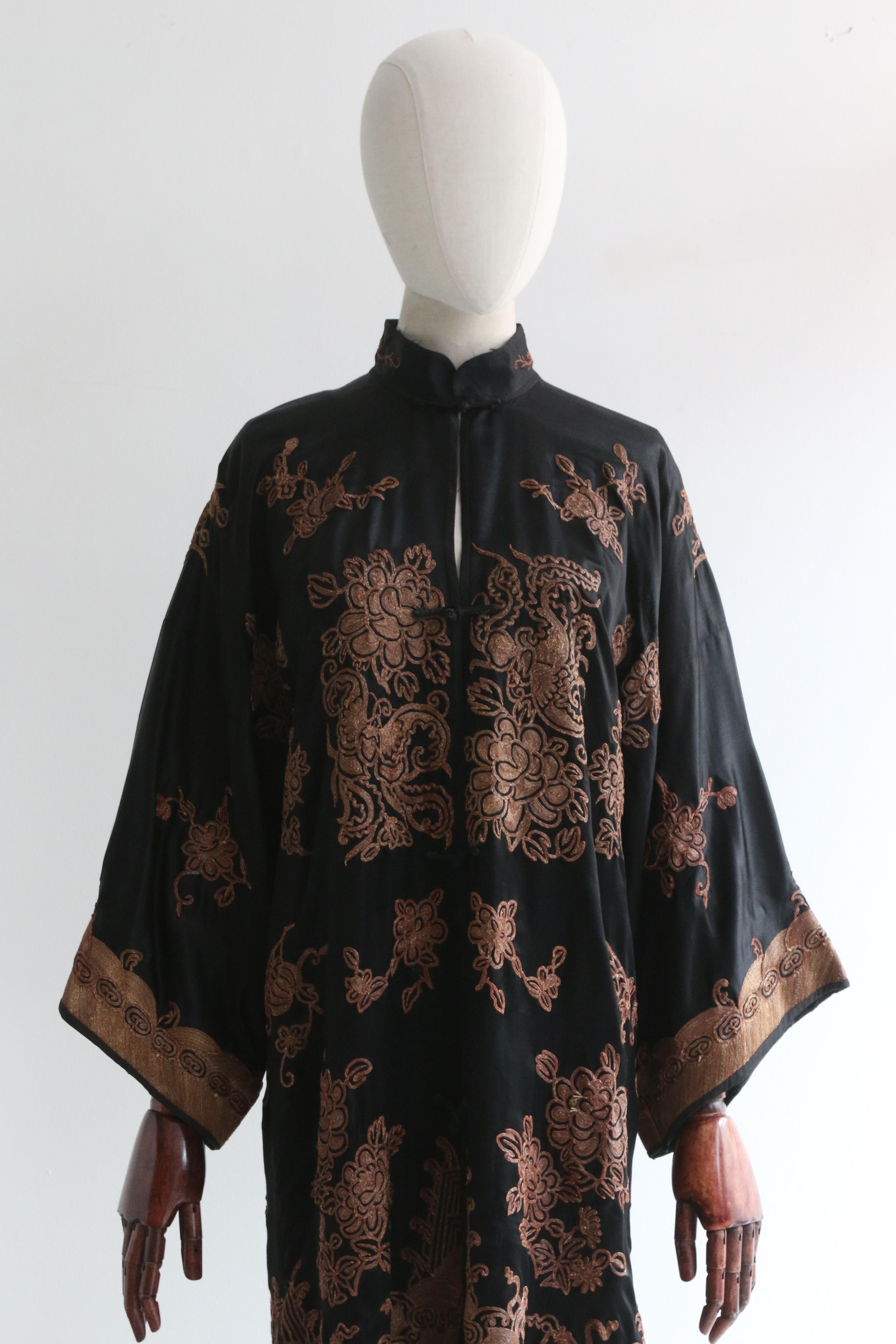 This original 1920's black silk jacket, embellished with gold metal thread embroidery and terracotta thread accents, in a wonderful floral and geometric pattern, is a rare piece to behold and the perfect statement piece for your wardrobe. 

The