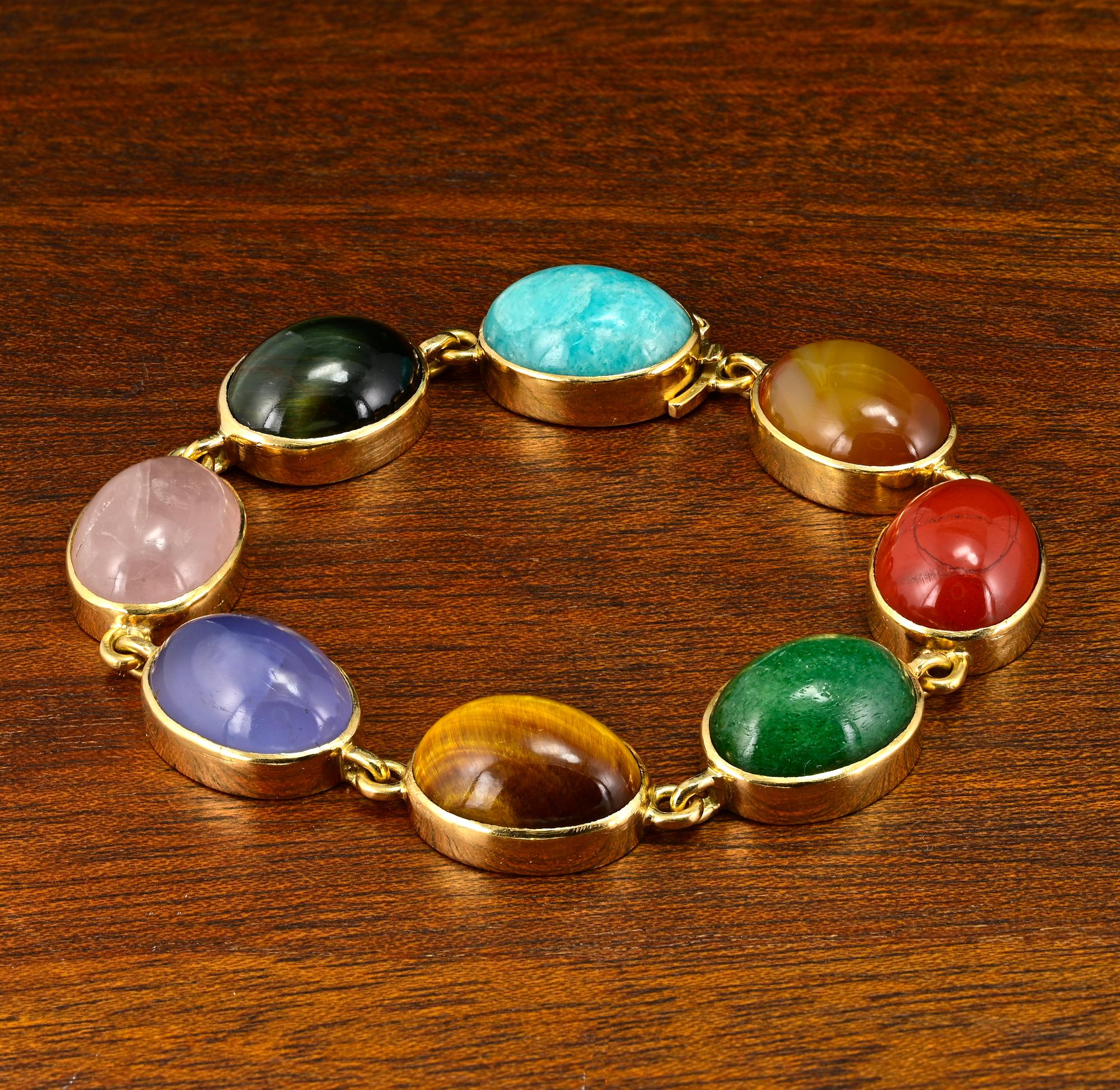 This charming vintage bracelet is 1930 circa
Italian origin hand crafted of solid 18 Kt gold, marked
Displaying a gorgeous array of 8 natural earth mined large gemstones set as follow: oval cabochon cut hard stones as follow: aragonite - black cat’s