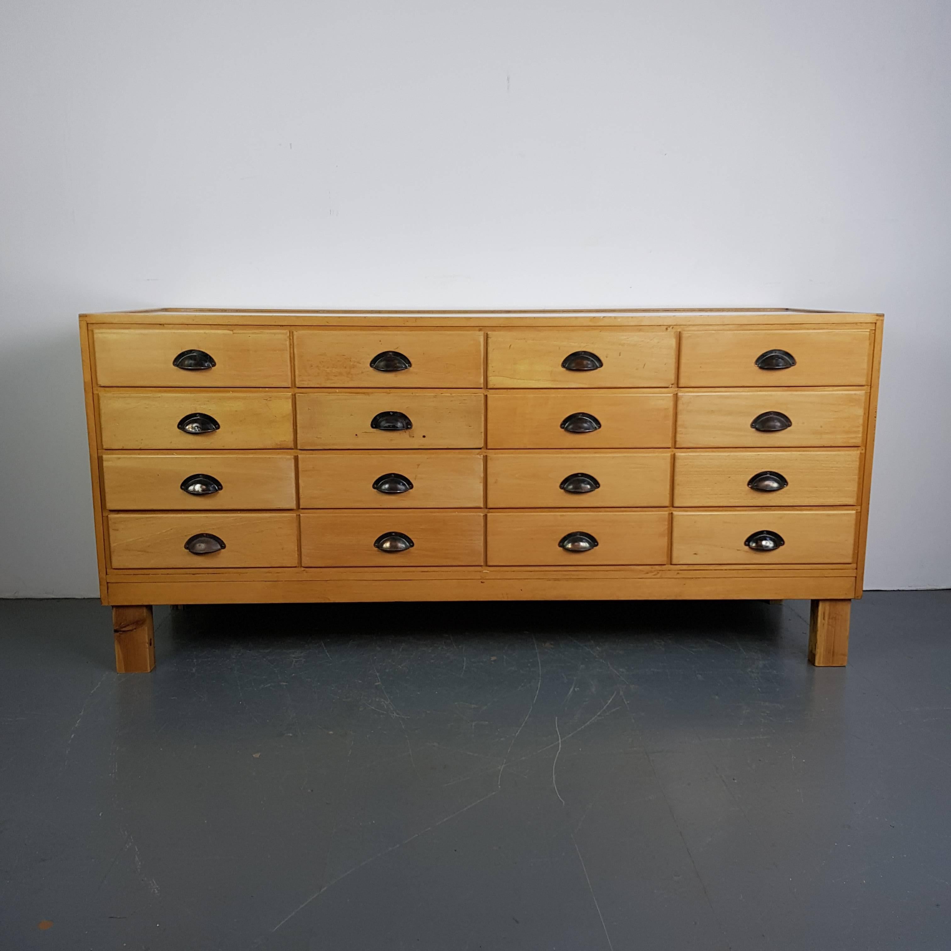 Lovely oak 16-drawer shop counter. Solid oak frame and drawer fronts. Glass casing. 

In good vintage condition. Some wear and tear commensurate with age, but nothing which detracts. Some small nicks and scuffs here and there.

If you bear in