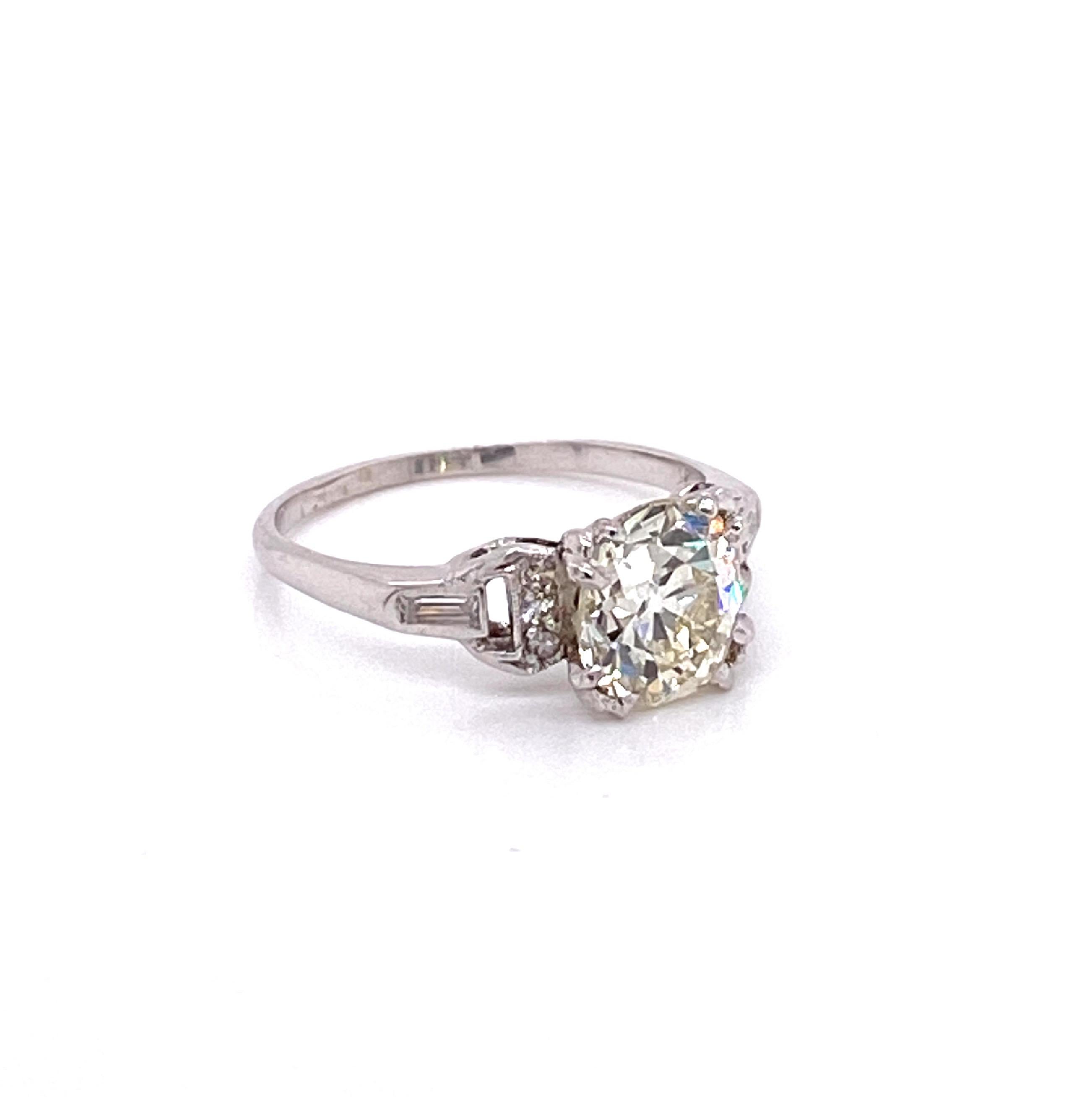 Vintage 1930s Old Mine Cut Diamond Art Deco Engagement Ring - The center Old Mine cut diamond weighs 1.83ct with M color and VS2 clarity. The diamond sits low in a platinum fishtail head. On either side of the Art Deco setting are 3 single cut