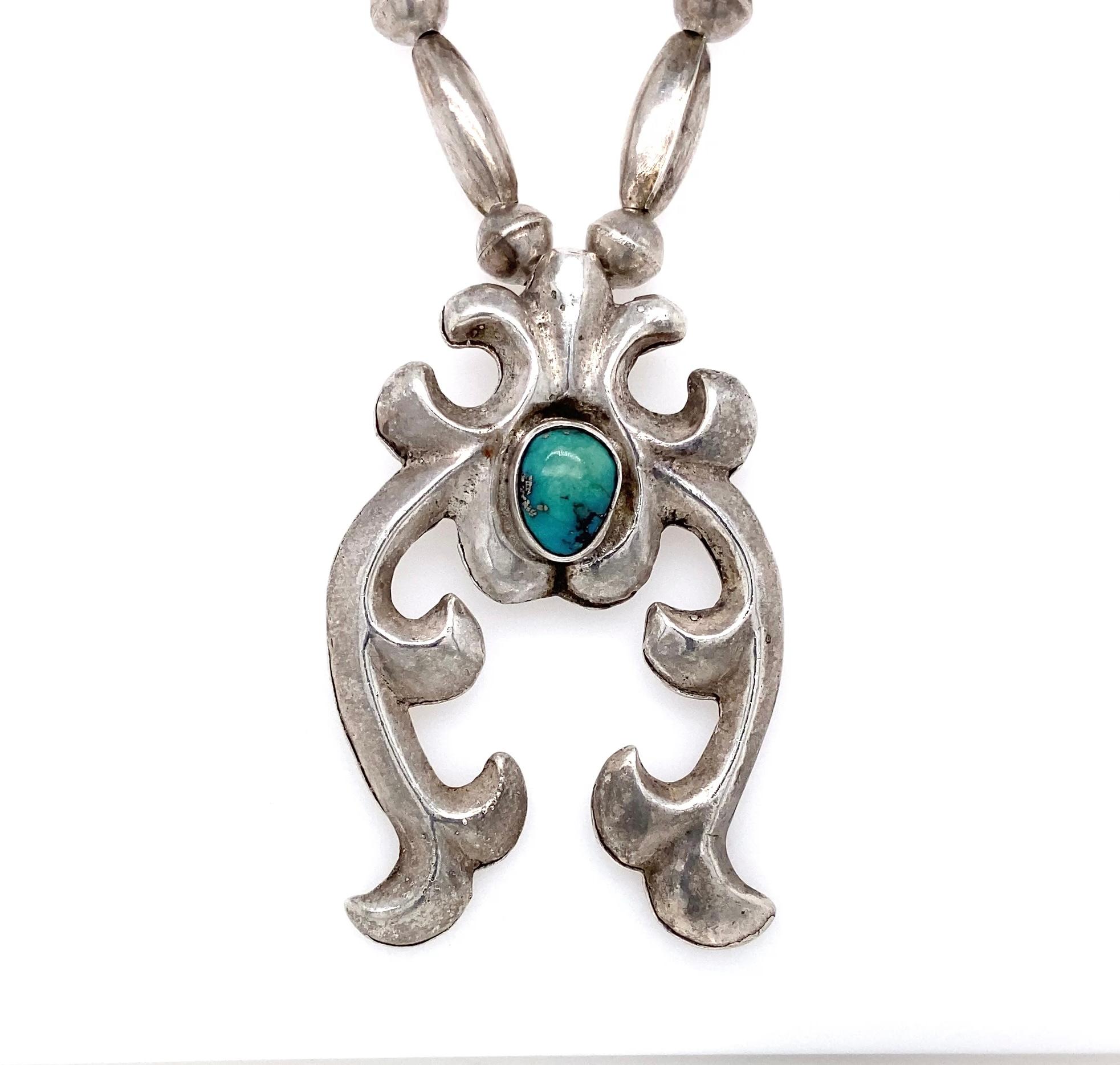 A striking piece of early 20th-century Navajo artistry, this vintage Navajo necklace is a fine example of traditional sand-cast silverwork and hand craftmanship from the 1930s - 1940s.
The bold sterling silver Naja pendant measures approximately 2