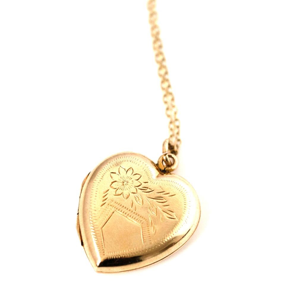 This magnificent vintage 1930s 9ct Gold Heart Locket is a timeless piece of jewellery that exudes romance. Dating back to the Victorian era, the locket is associated with romantic love and has been used as a token of significant moments in people's