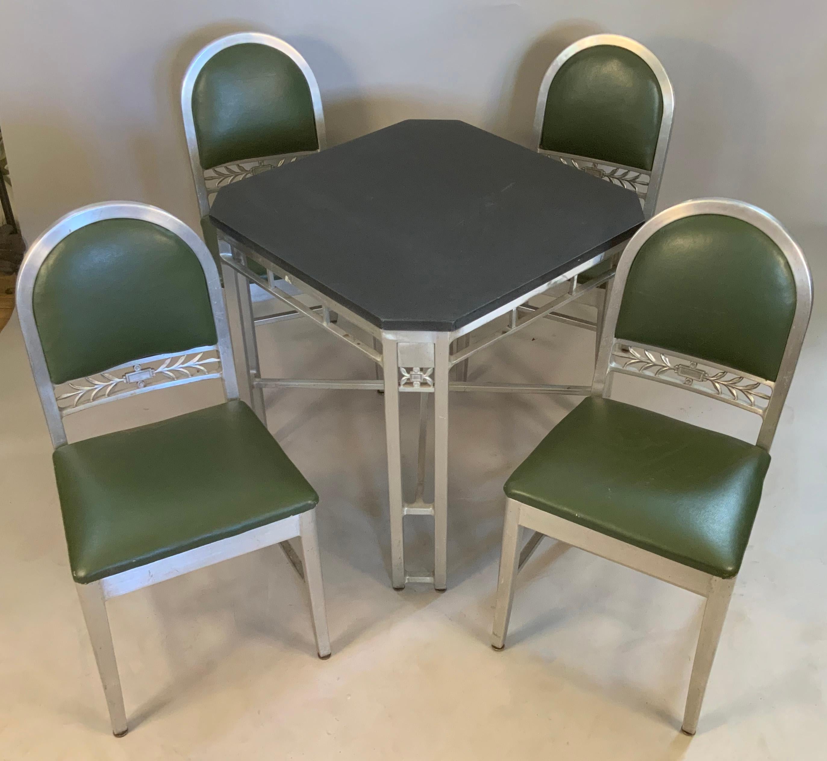 A very handsome 1930's slate top aluminum table and set of 4 matching chairs commissioned for a restaurant called The Silver Grille in Cleveland. Goodform was well known for producing iconic aluminum furniture in the 30's and 40's, and this set has