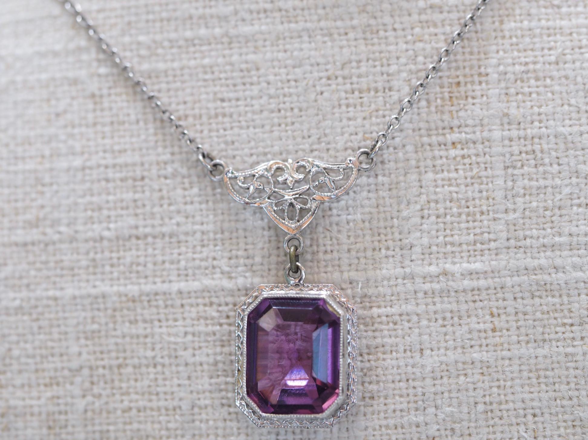 Vintage Art Deco 1930's Amethyst Necklace includes a beautiful brilliant purple amethyst center. The center measures 11.50 X 9.50mm weighing approximately weighing 4.31 carats. The amethyst is bezel set with filigree hanging from a bail with