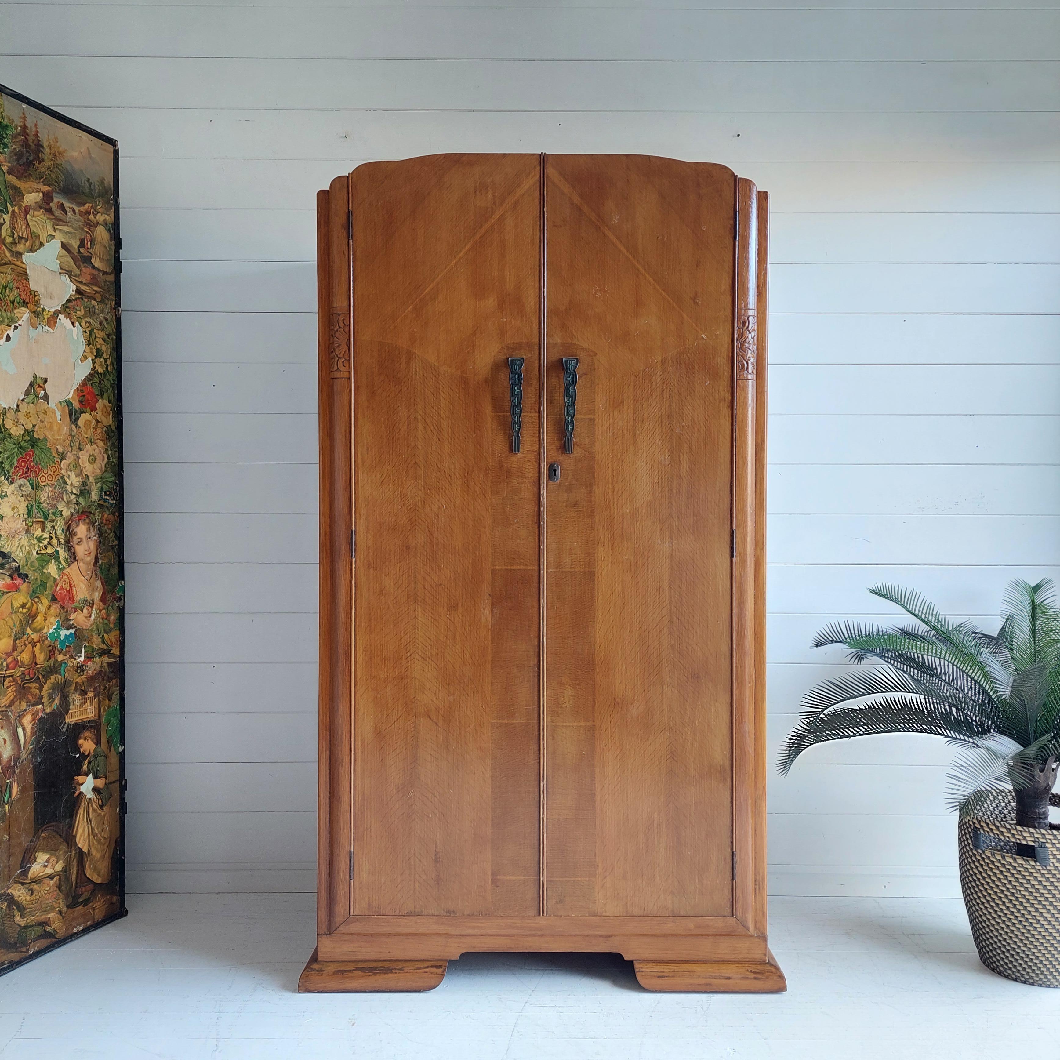 Late Art Nuveau/Art Deco Single Wardrobe.
This was made probably in England, it dates from the 1930’s.

Standing Upon a Shaped Plinth.
Featuring 2 Highly Figured oak Doors with a Shaped Closing Mould, the Doors Retain their Original Art Deco/