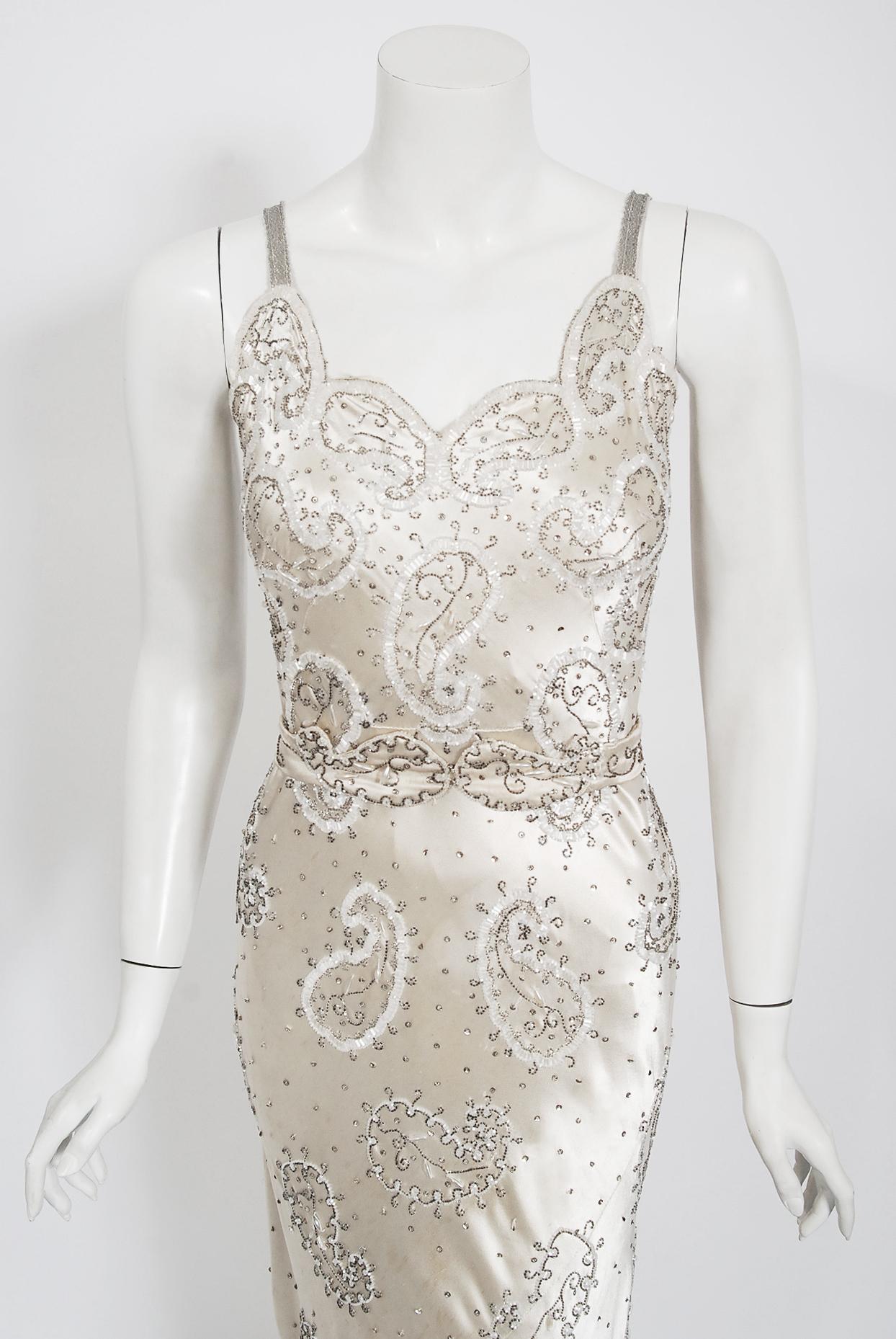 A stunning 1930's shimmering ivory creme silk-satin gown from the 