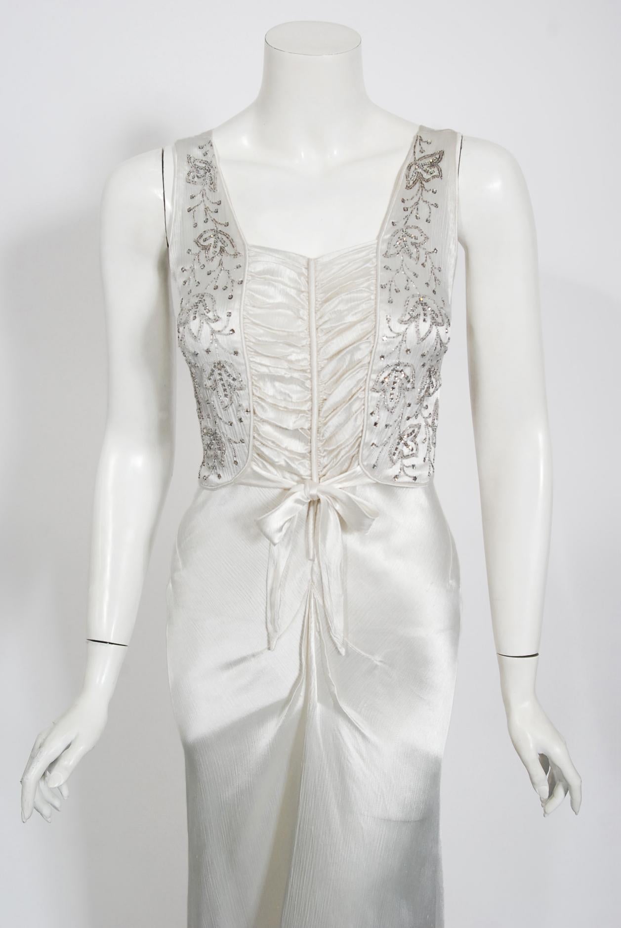 A breathtaking ivory white liquid silk satin gown dating back to the mid-1930's Old Hollywood era of glamour. So Jean Harlow! I have never seen such a romantic bodice; a slight sweetheart gathered front-tie with covered buttons running down the