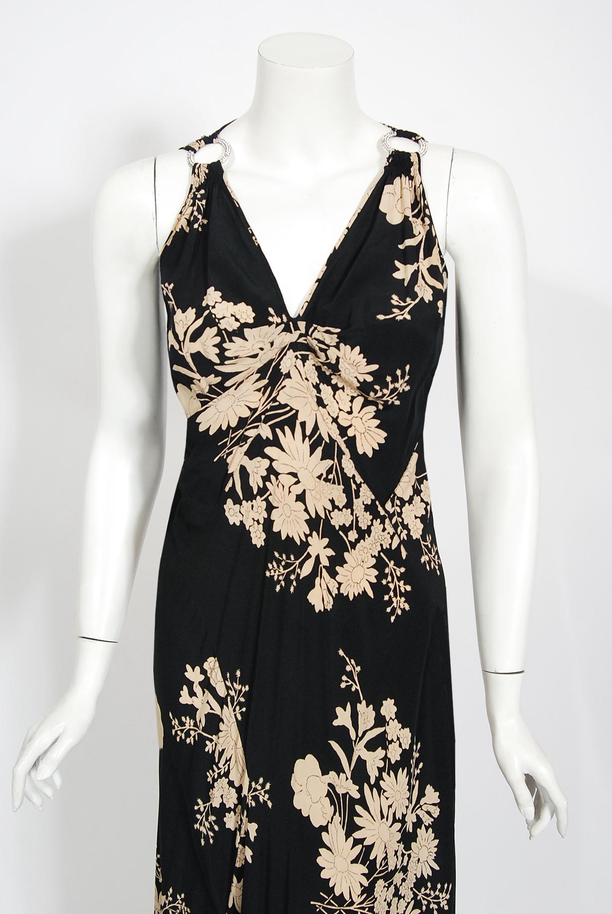 The breathtaking ivory and black floral garden print used on this 1930's hourglass silk gown has a timeless quality that I find irresistible. The impressive bodice has rhinestone paste circular accents on both sides with complex shoulder strap