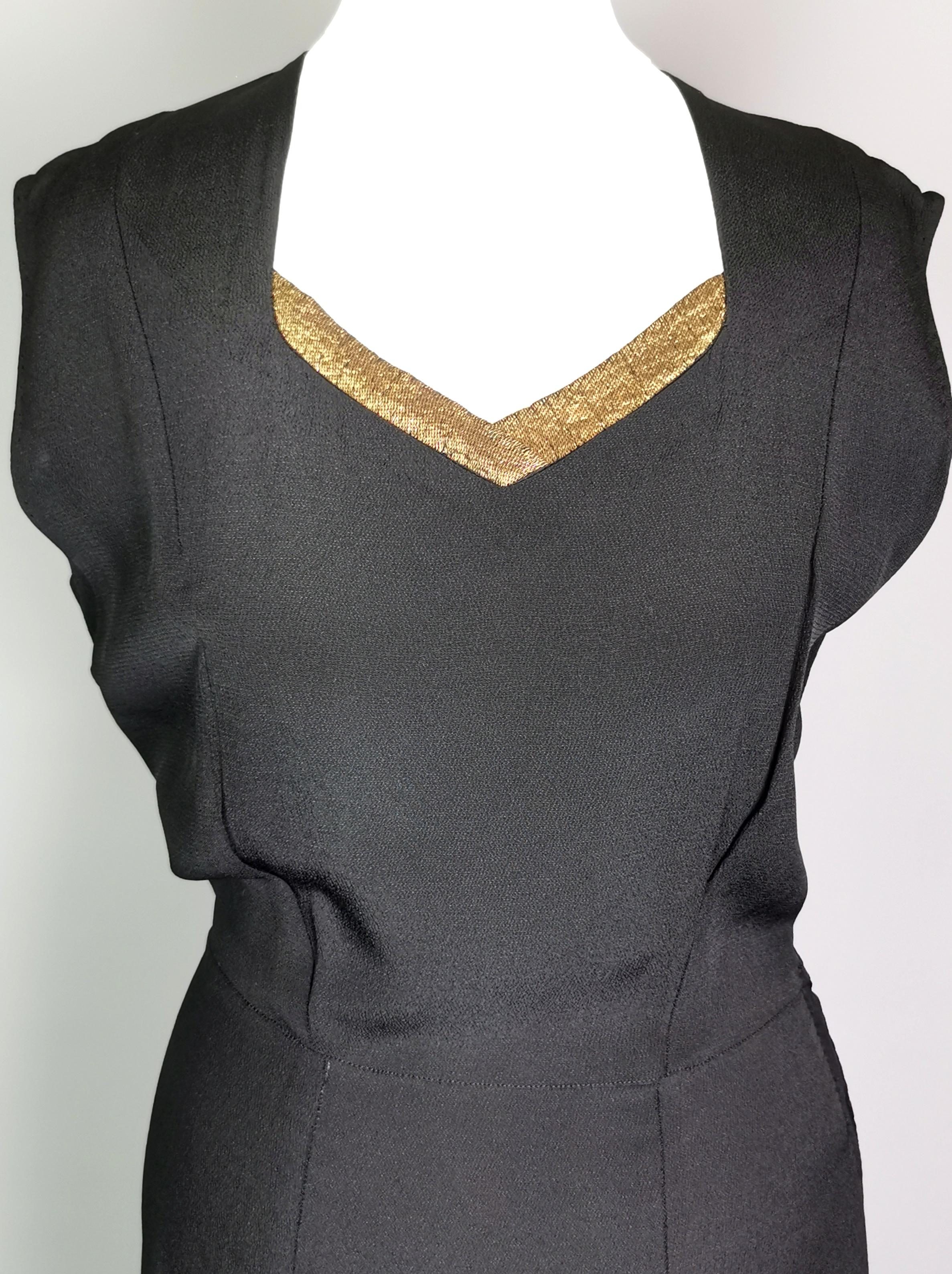 A gorgeous vintage 1930's Black bombshell evening dress.

A slinky black crepe rayon dress with a v neck, cinched in at the waist with a long skirt and a gold lame trim neckline.

It has a figure hugging silhouette with some stretch to the material,