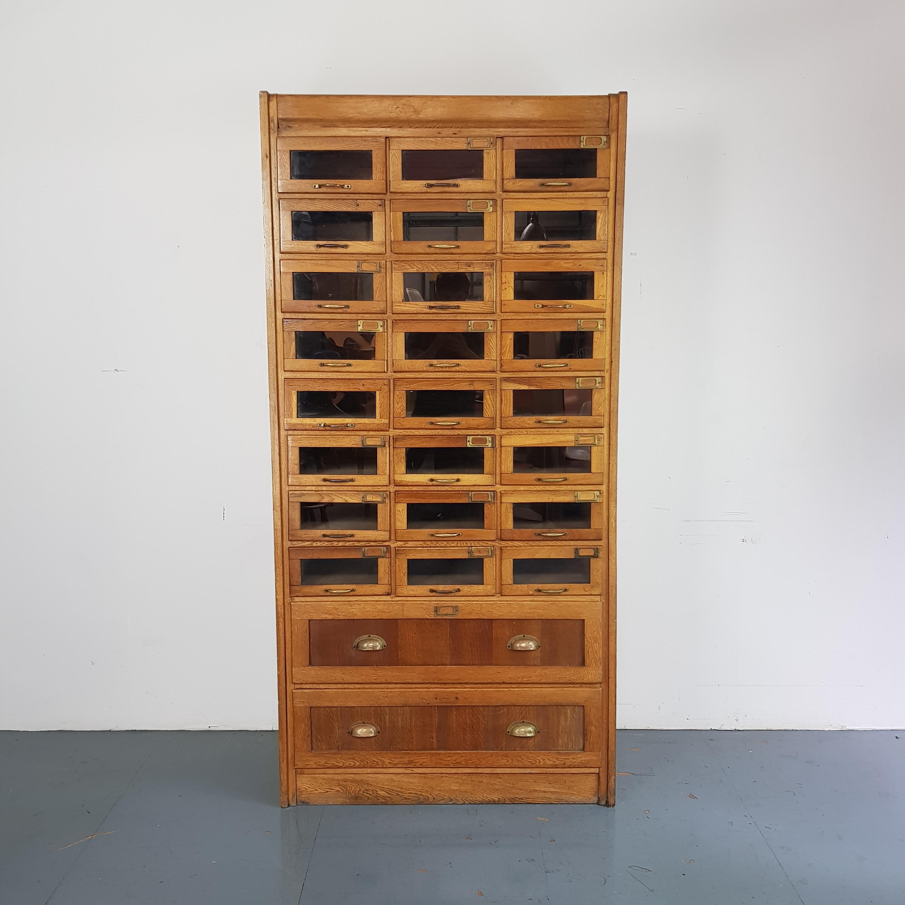 Lovely vintage haberdashery shop cabinet. 

This would add instant impact in a reception room, bedroom or hall. 

It has 24 small glass fronted drawers and two solid drawers, all with original metal handles. 

Dimensions:

Width