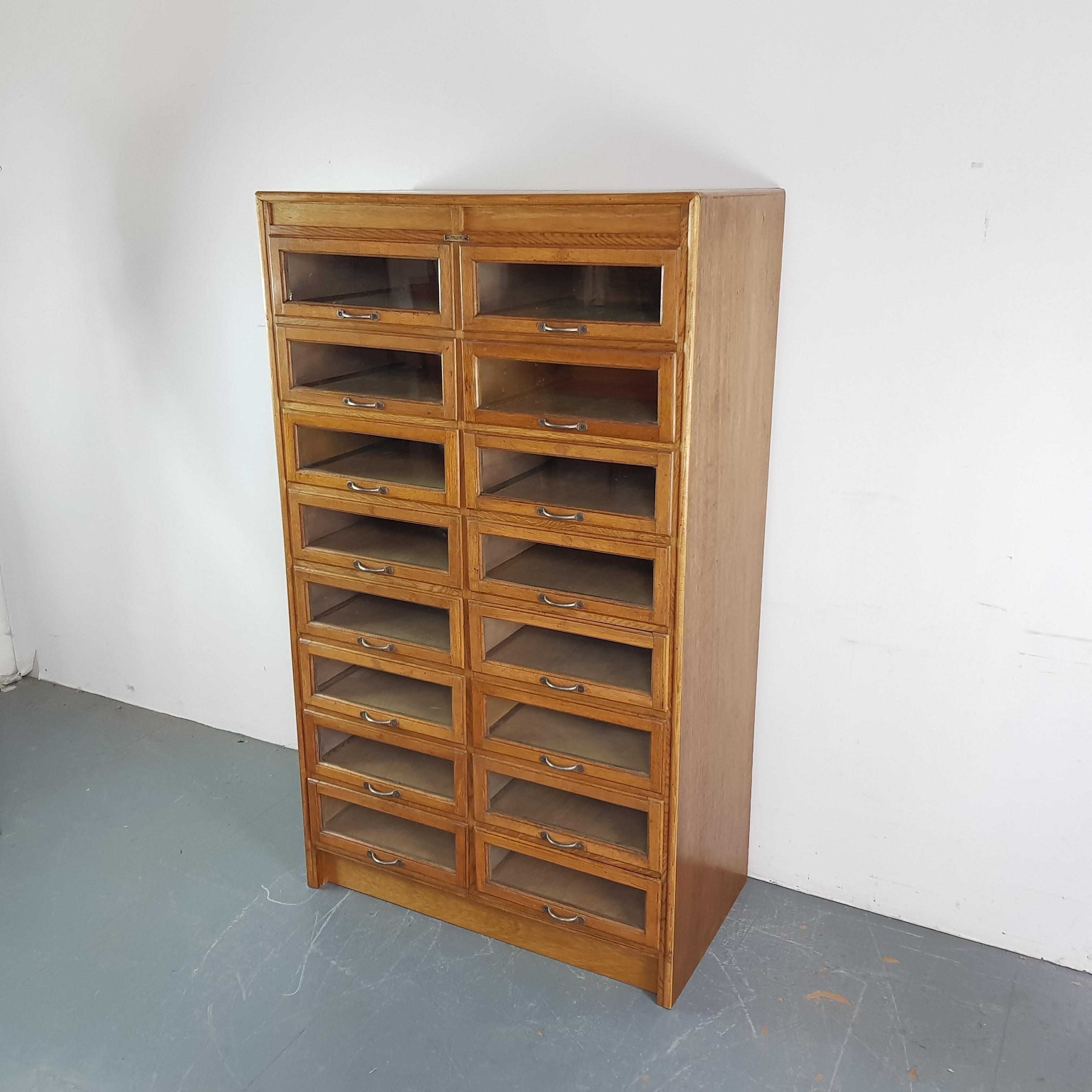 Lovely 16-drawer haberdashery shop cabinet from the 1920s-1930s.

It has 16 glass fronted drawers. 

In good vintage condition. Some scuffs here and there, commensurate with age, but no specific wear to mention. Please bear in mind this has come