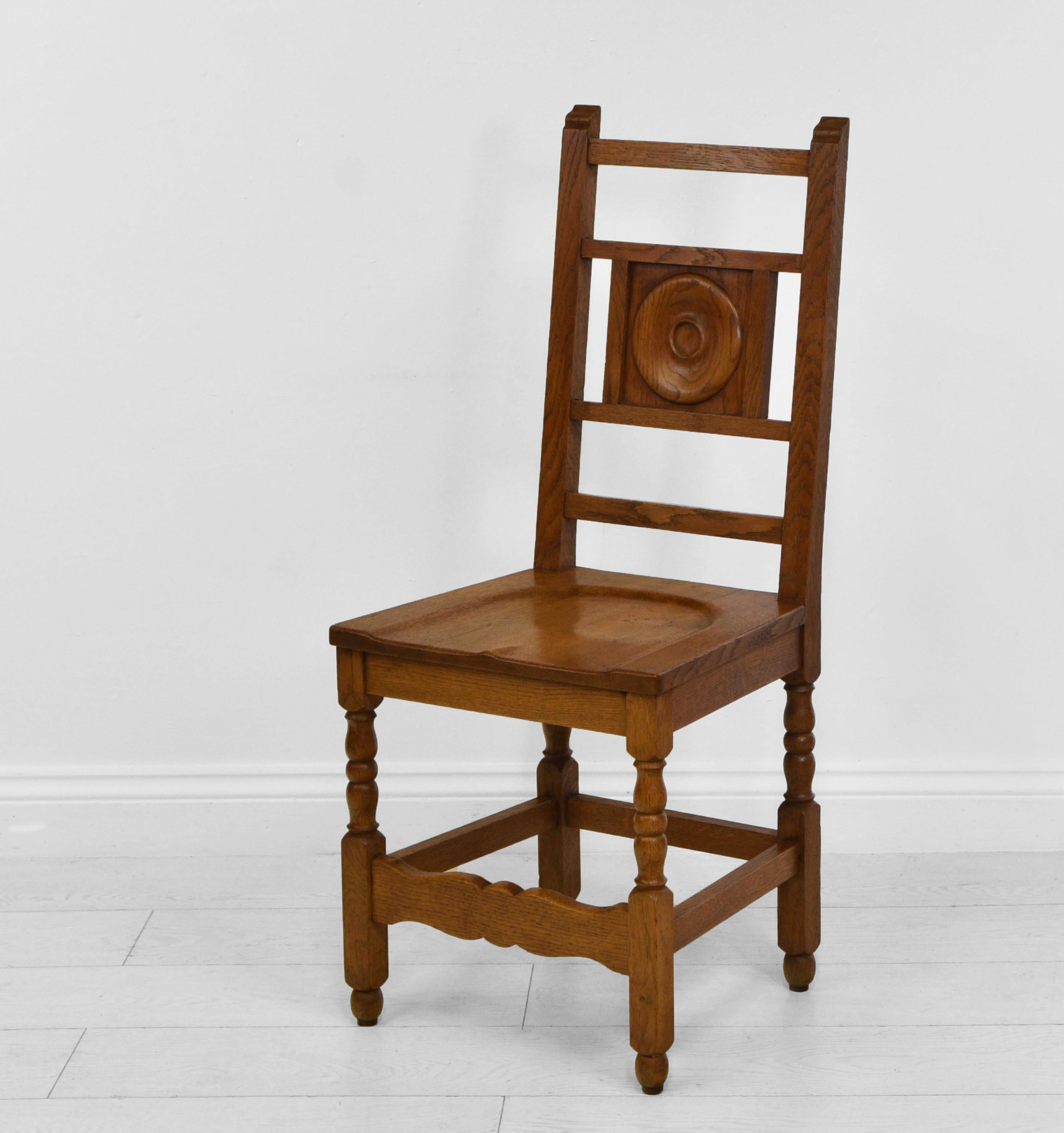 Set of eight oak chairs in the Heal's manner, reputably from the University of Cambridge. Circa 1930.

The chairs are made in solid oak and have shaped seats, making for comfy seating. Overall they are in very good condition for their age, showing